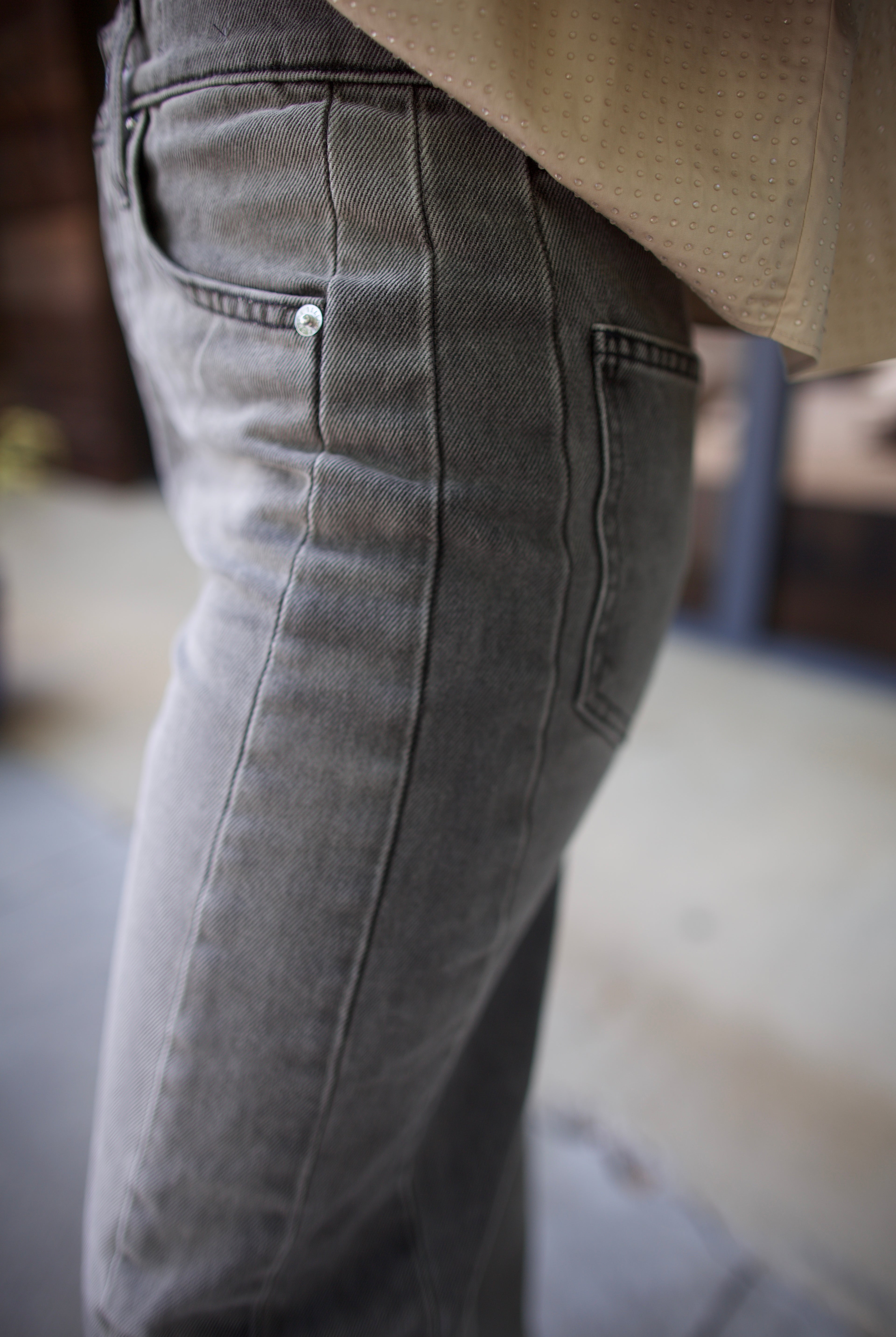 Mature model wearing designer brand Veronica Beard high rise Ryder grey barrel denim fabricated with rigid cotton