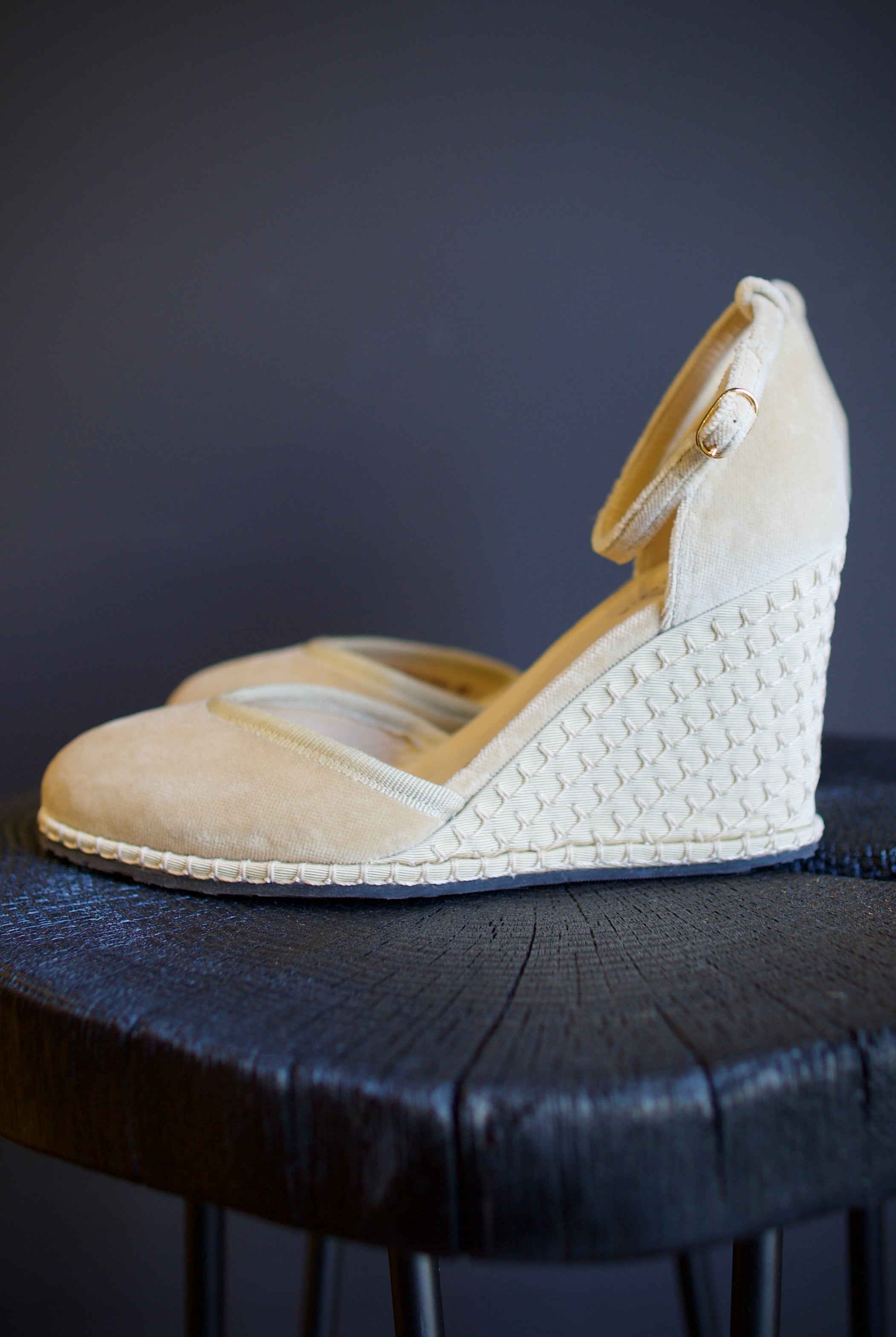 A pair of beige Vibi espadrille wedge heels in beautiful neutral velvet with  round toe, ankle straps and buckle closures.