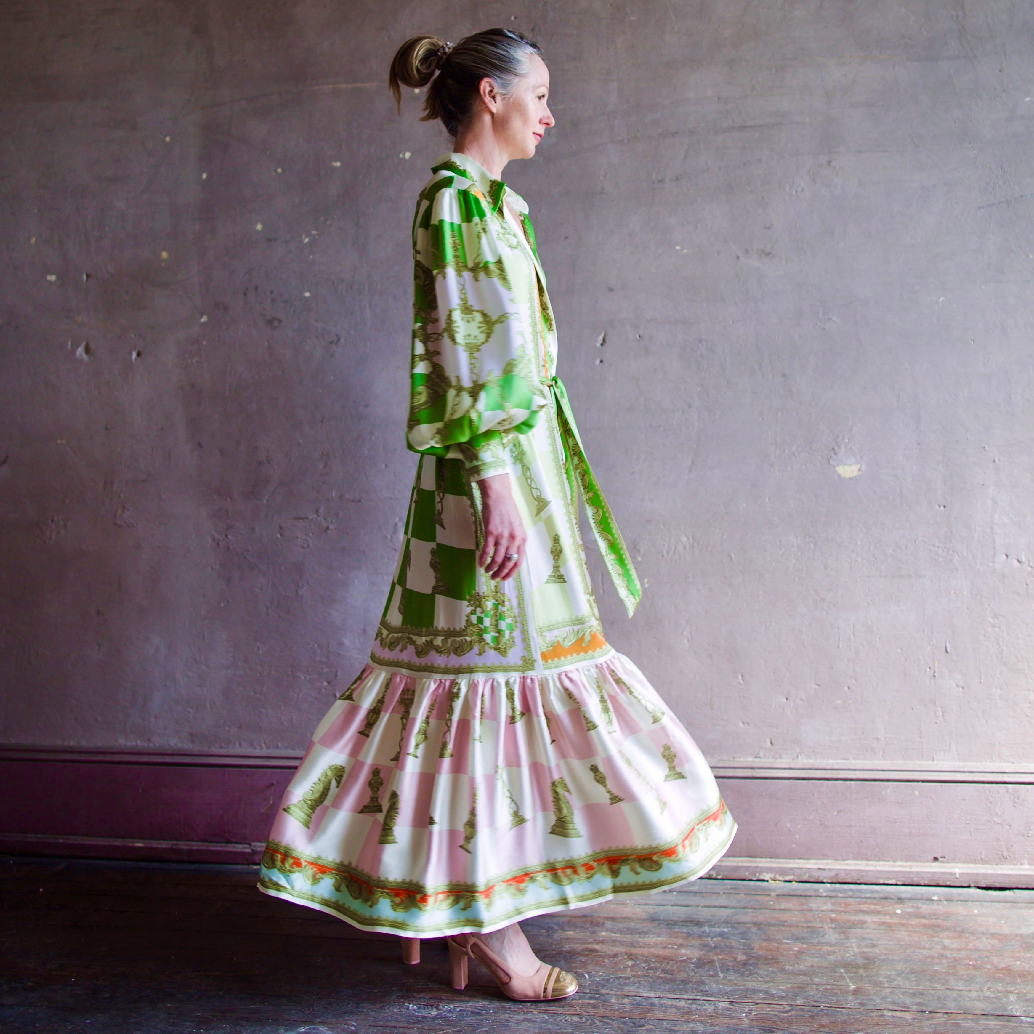 Image featuring a woman wearing the Checkmate midi shirtdress from Alemais with gathered balloon sleeve & button cuff, and a self-tie belt in sand washed silk.