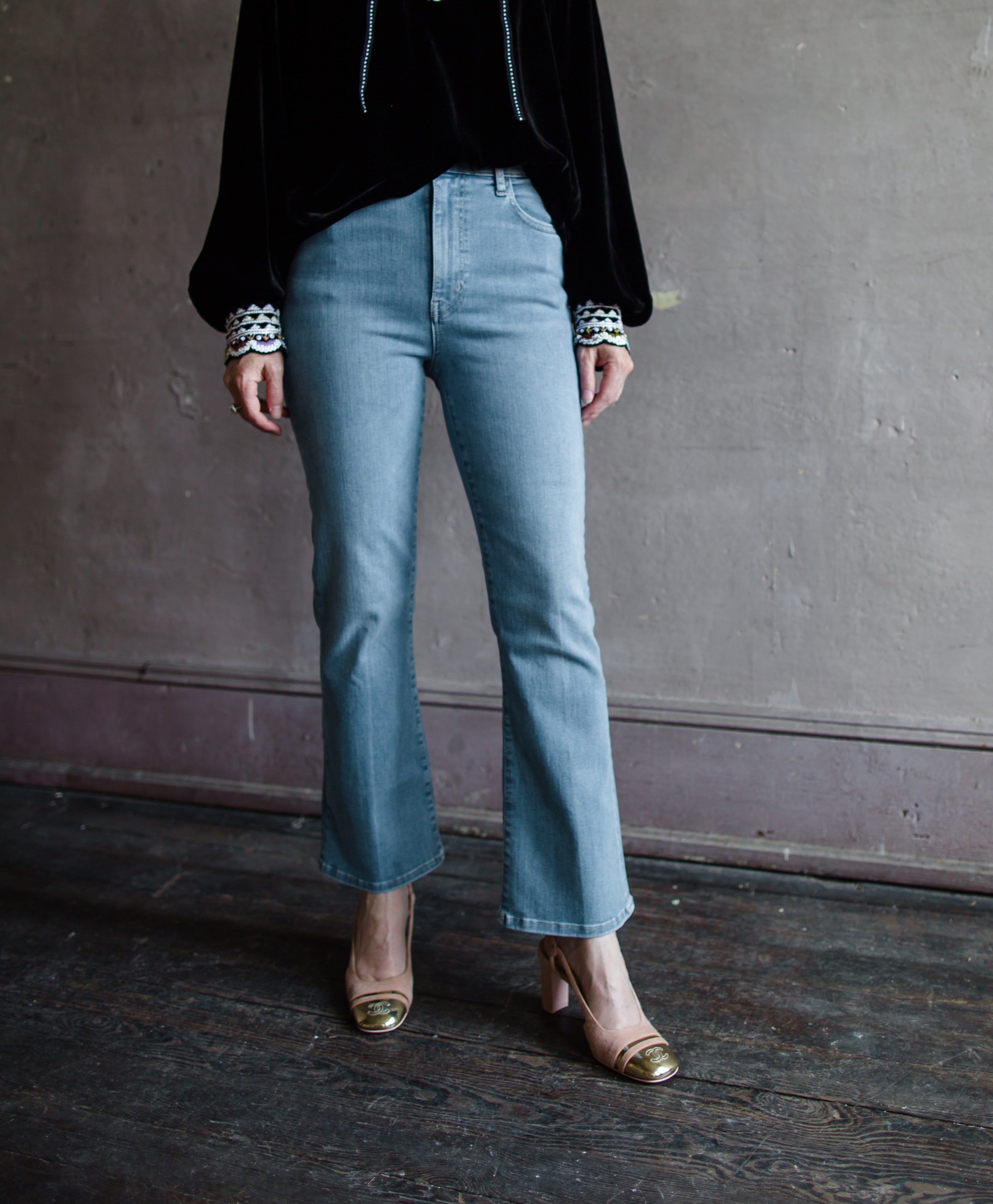 Image of woman wearing the Frame Le Crop mini bootcut jeans and Ulla Johnson Julien velvet top