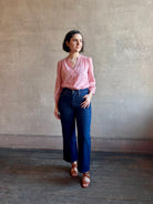 Woman wearing AGOLDE Harper rigid cotton Denim in Reissue dark wash with a cropped finish hem and no distressing