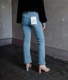 Image of the back of a woman wearing the Frame Le Crop mini bootcut jeans and Ulla Johnson Julien velvet top