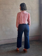Woman wearing AGOLDE Harper rigid cotton Denim in Reissue dark wash with a cropped finish hem and no distressing