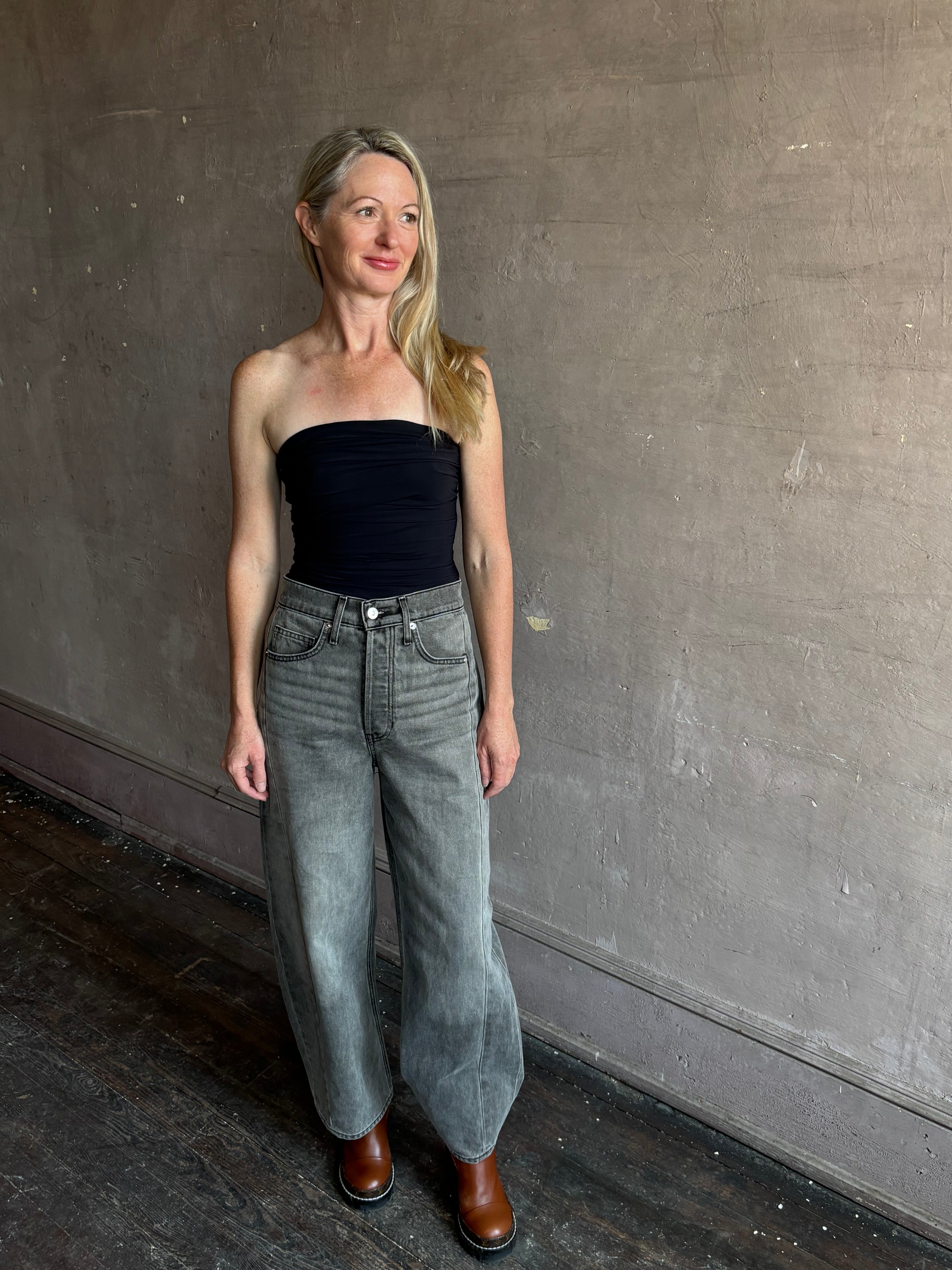 Image of mature woman wearing AGOLDE Gwyneth Bodysuit in black with premium stretch for timeless versatile styling 