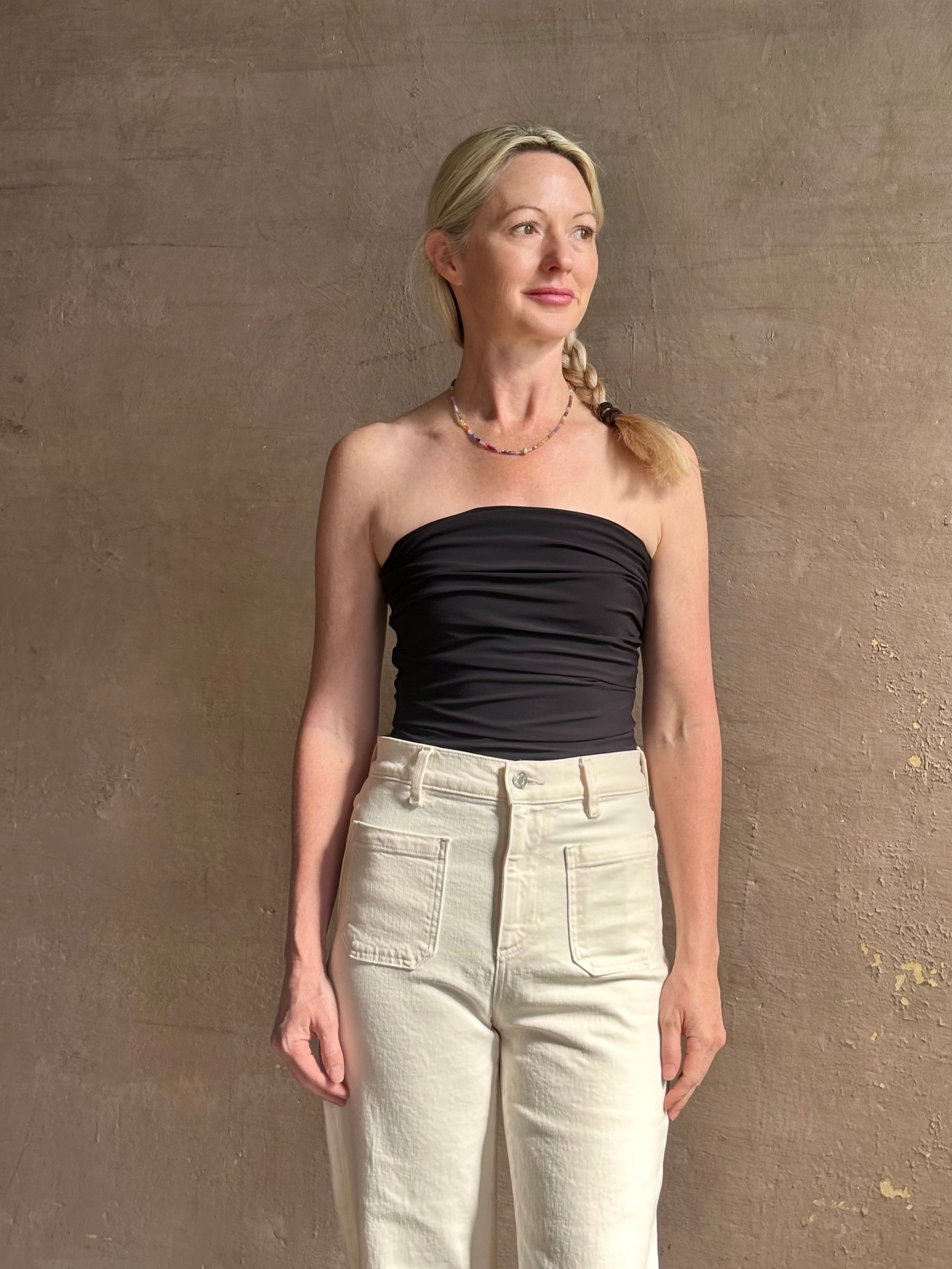 Mature woman wearing AGOLDE Gwyneth Bodysuit in black with premium stretch for timeless versatile styling 