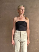 Mature woman wearing AGOLDE Gwyneth Bodysuit in black with premium stretch for timeless versatile styling 
