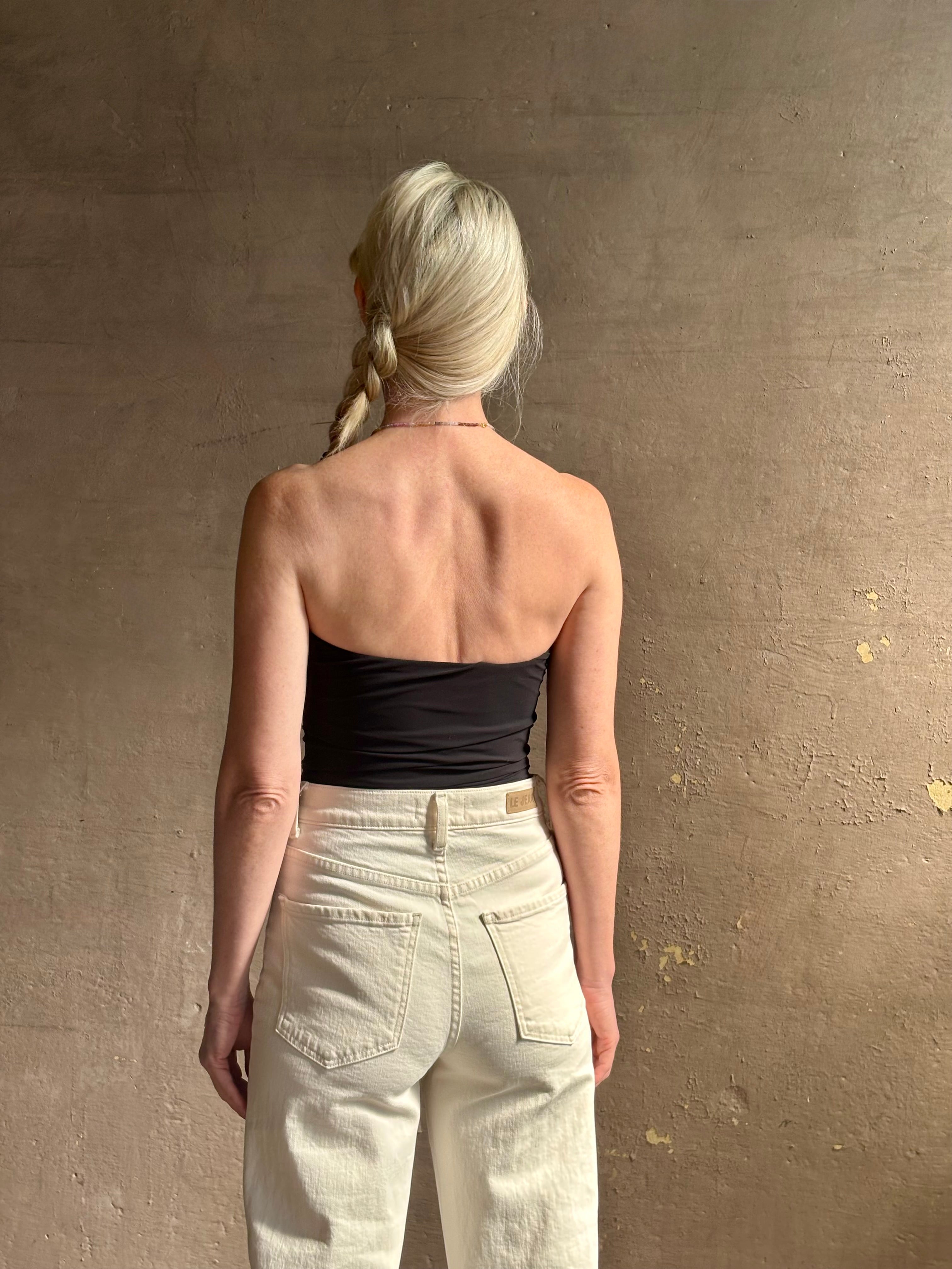 Mature woman wearing AGOLDE Gwyneth Bodysuit in black with premium stretch for timeless versatile styling 