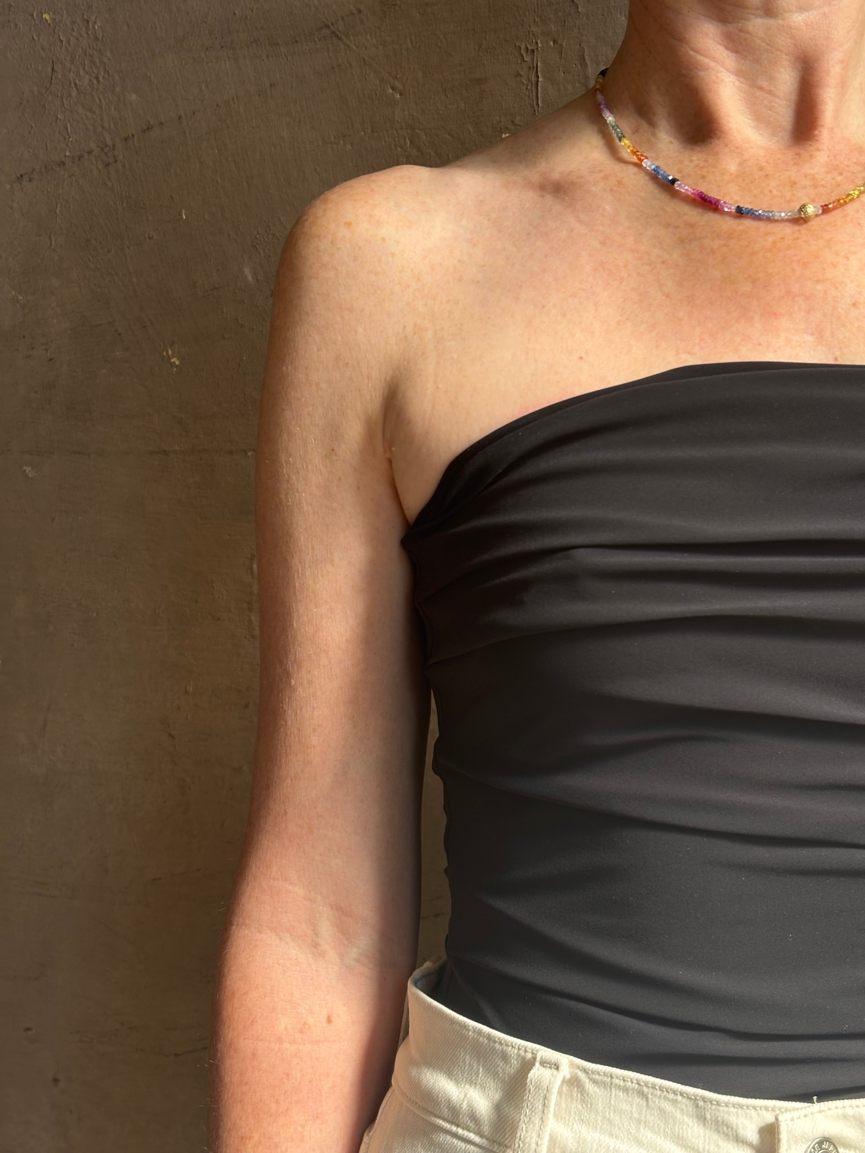 Mature woman wearing AGOLDE Gwyneth Bodysuit in black with premium stretch for timeless versatile styling 