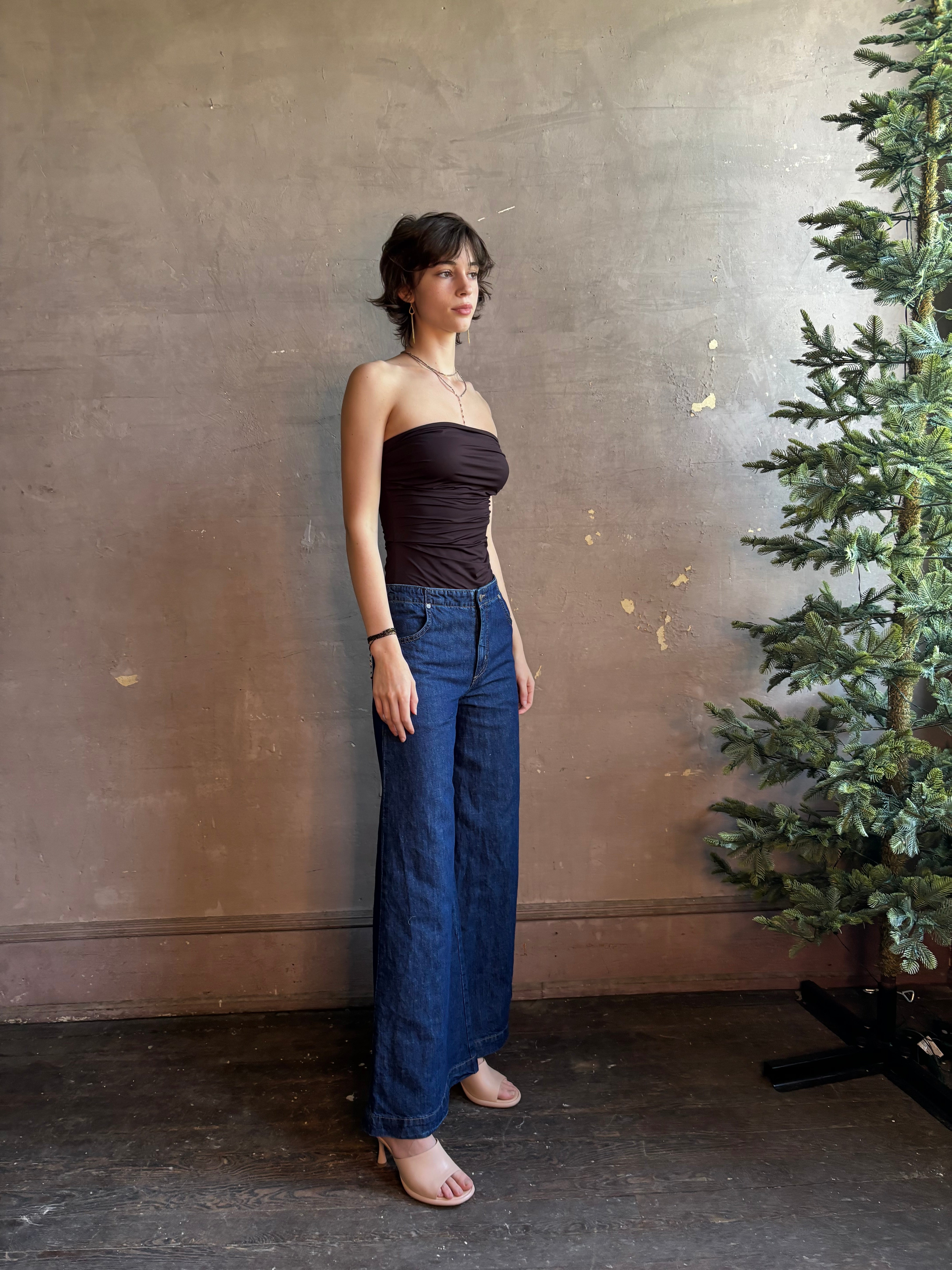 Woman wearing AGOLDE Gwyneth Bodysuit in chocolate brown with premium stretch for timeless versatile styling with gathered fabric body that is very forgiving while form fitted