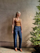Mature woman wearing Agolde 90's Pinch Waist Crop with regenerative cotton zip closure slim sihlouette