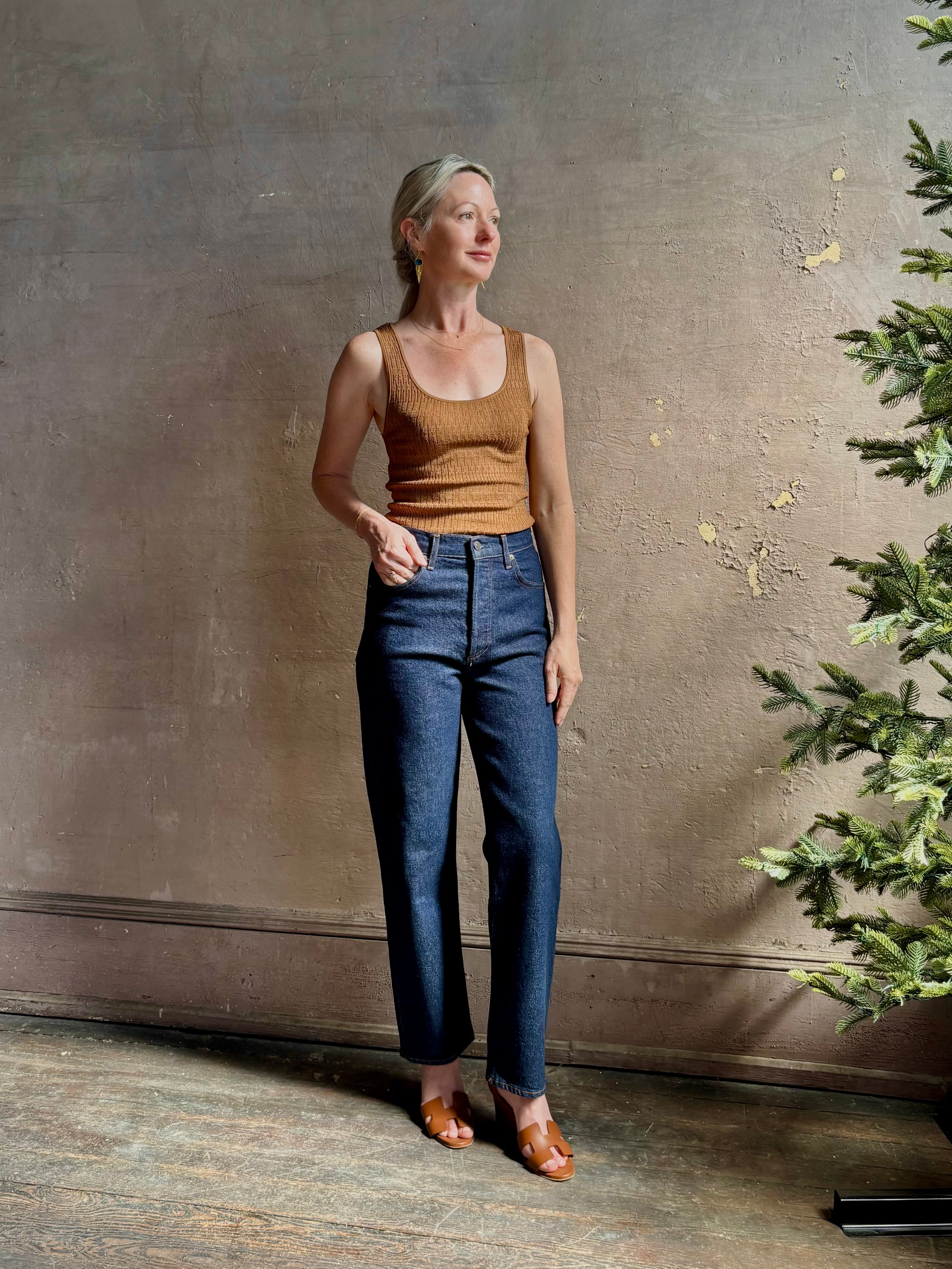 Mature woman wearing Agolde 90's Pinch Waist Crop with regenerative cotton zip closure slim sihlouette
