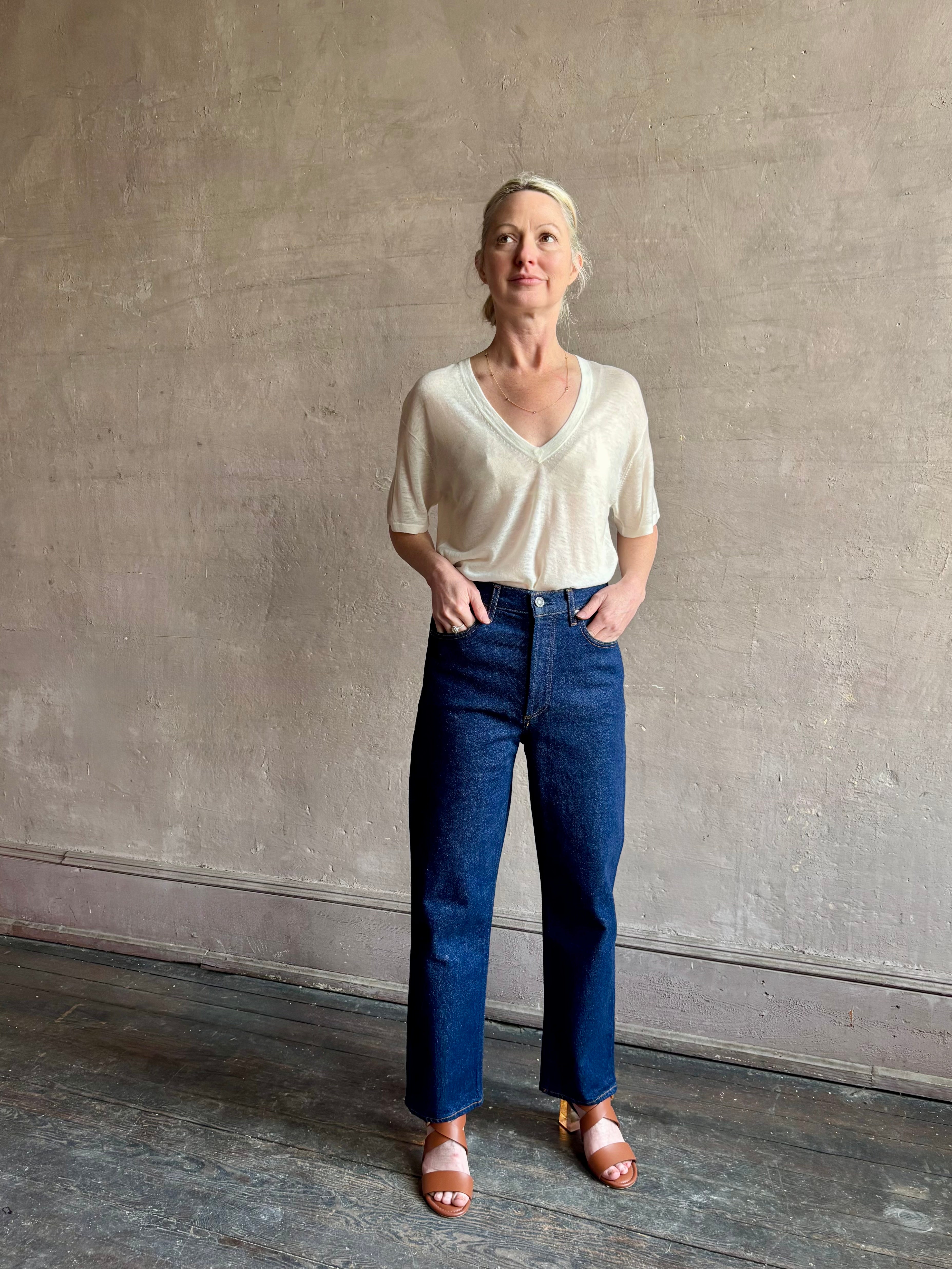 Image of woman wearing premium AGOLDE 90's Pinch Waist Crop in Reissue dark wash with high rise finished hem and slight taper straight leg