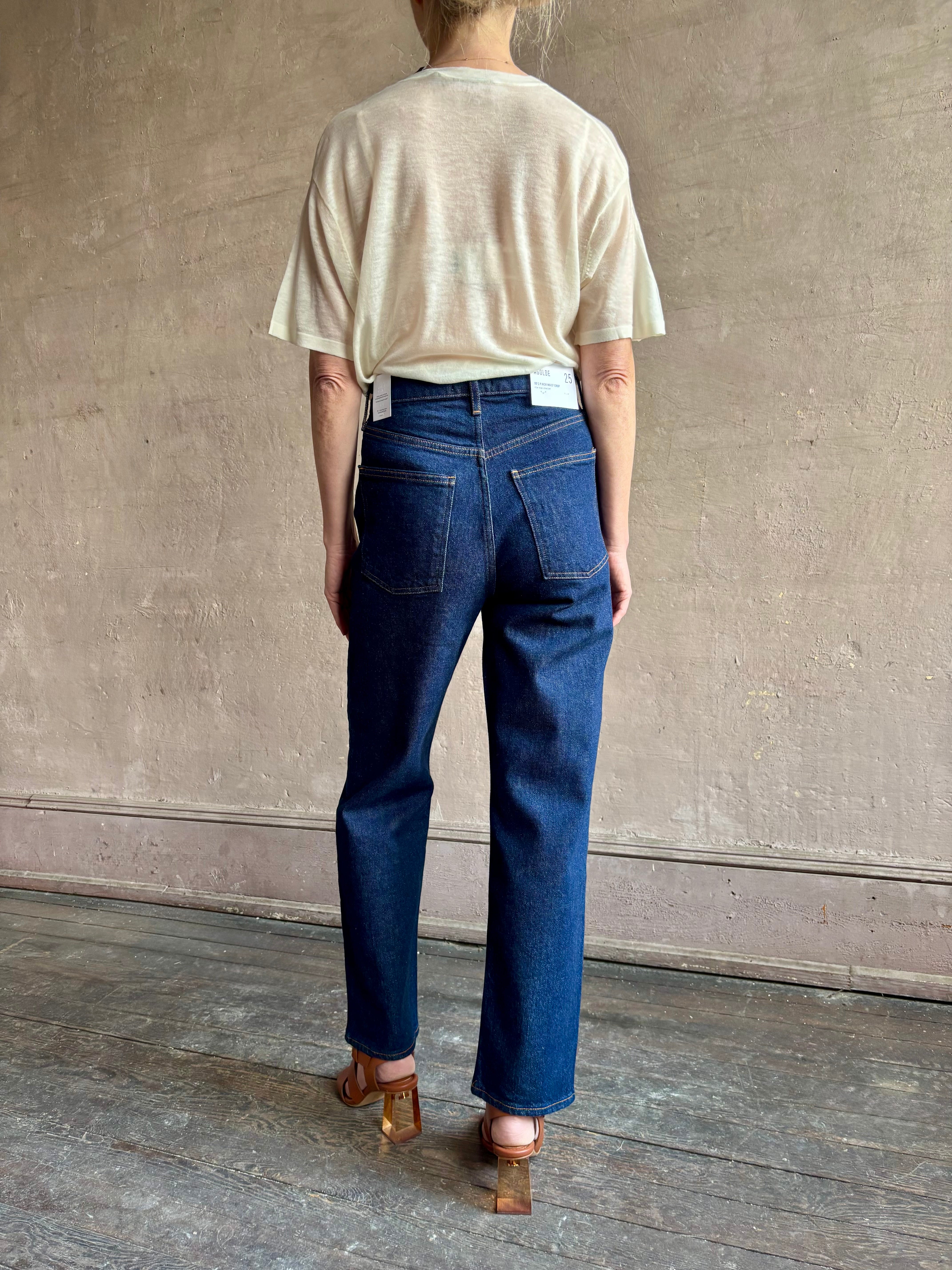 Image of woman wearing premium AGOLDE 90's Pinch Waist Crop in Reissue dark wash with high rise finished hem and slight taper straight leg