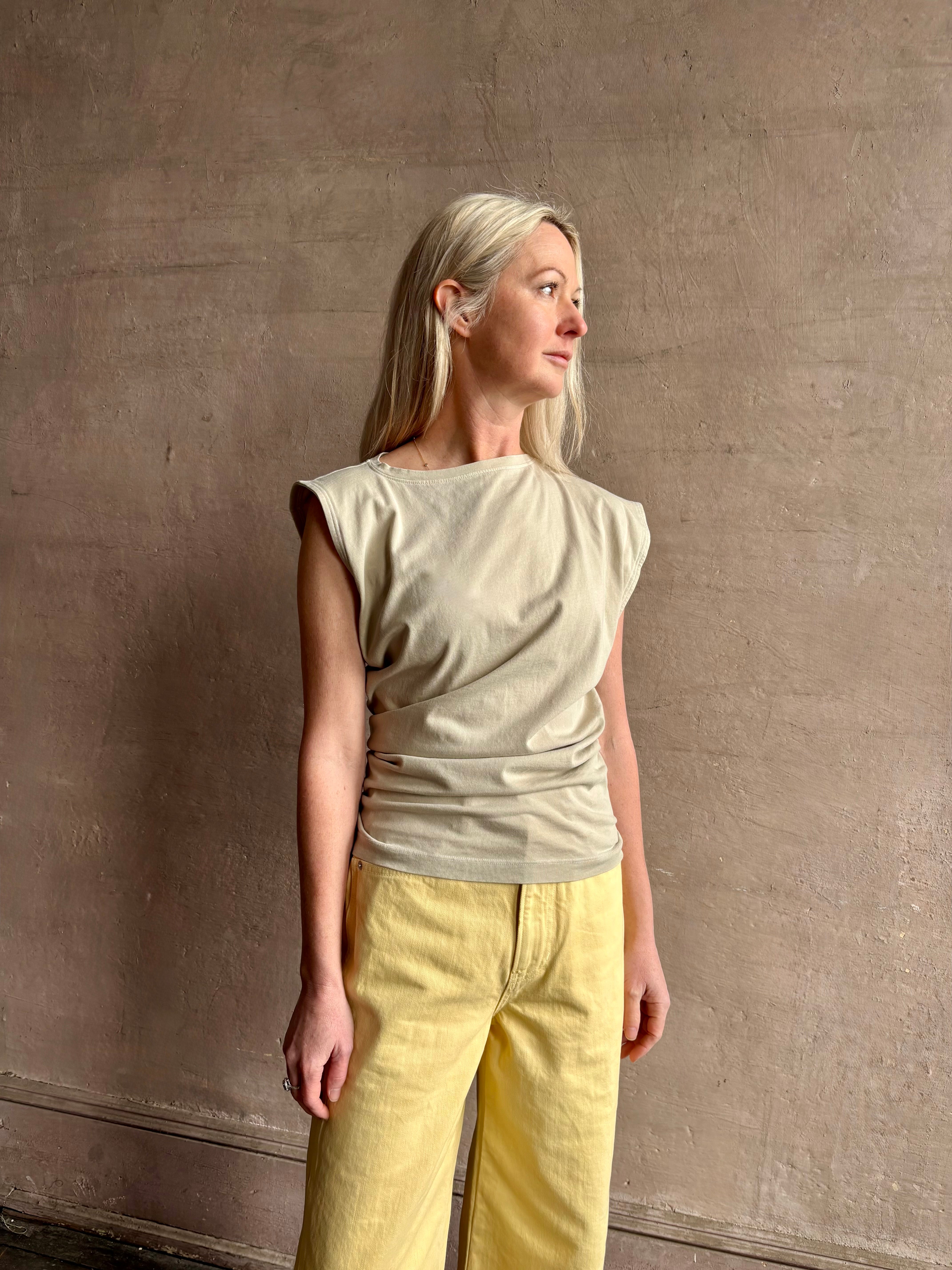 Image of woman wearing - Premium Organic Cotton Luxury Basics AGOLDE Beth Tee in Rice Grass beige with cap sleeves and draping