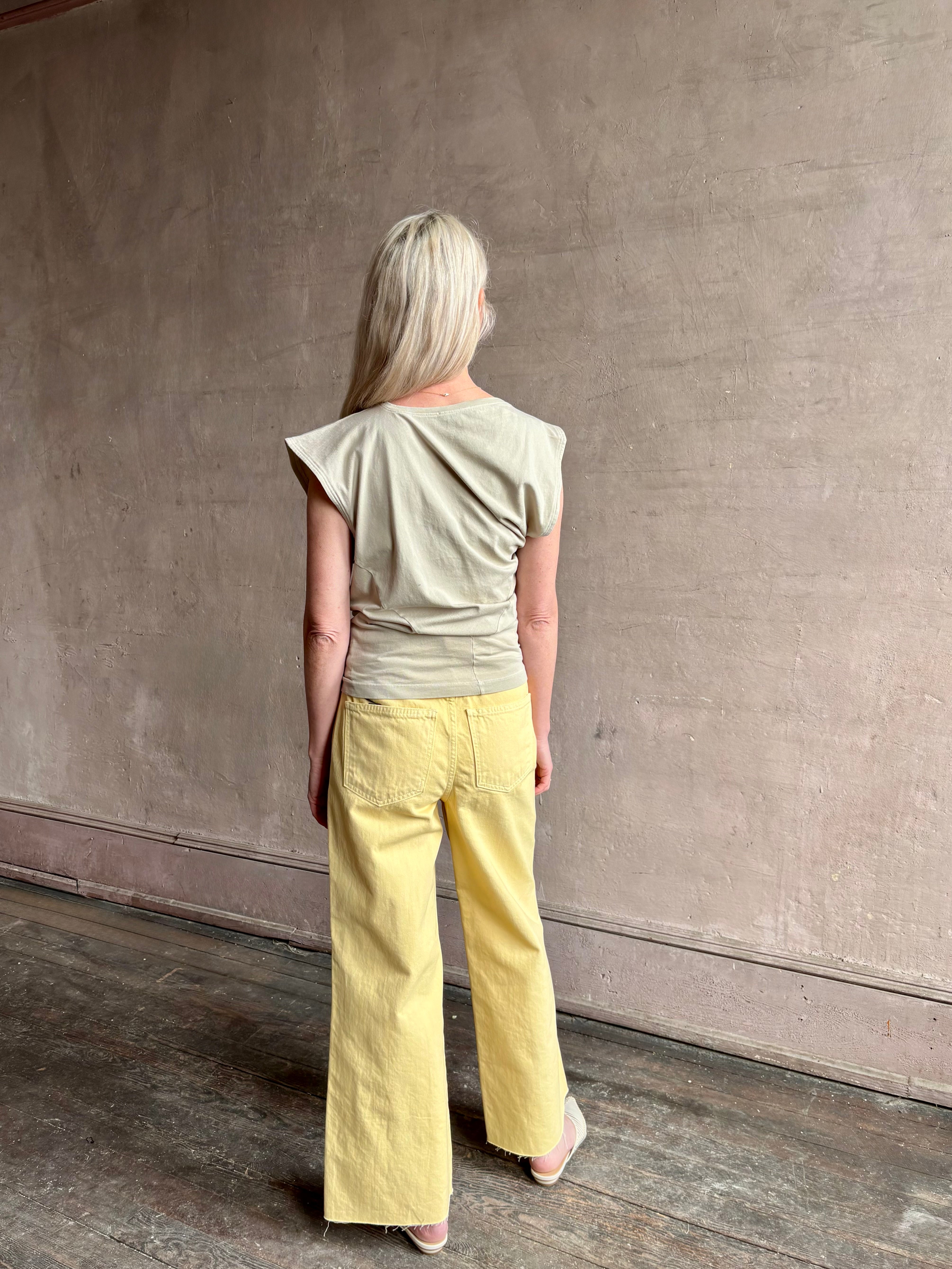 Image of woman wearing - Premium Organic Cotton Luxury Basics AGOLDE Beth Tee in Rice Grass beige with cap sleeves and draping