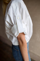 Model wearing The A.L.C. Jordan Top in White. Long sleeve blouse boasts premium cotton blend construction.
