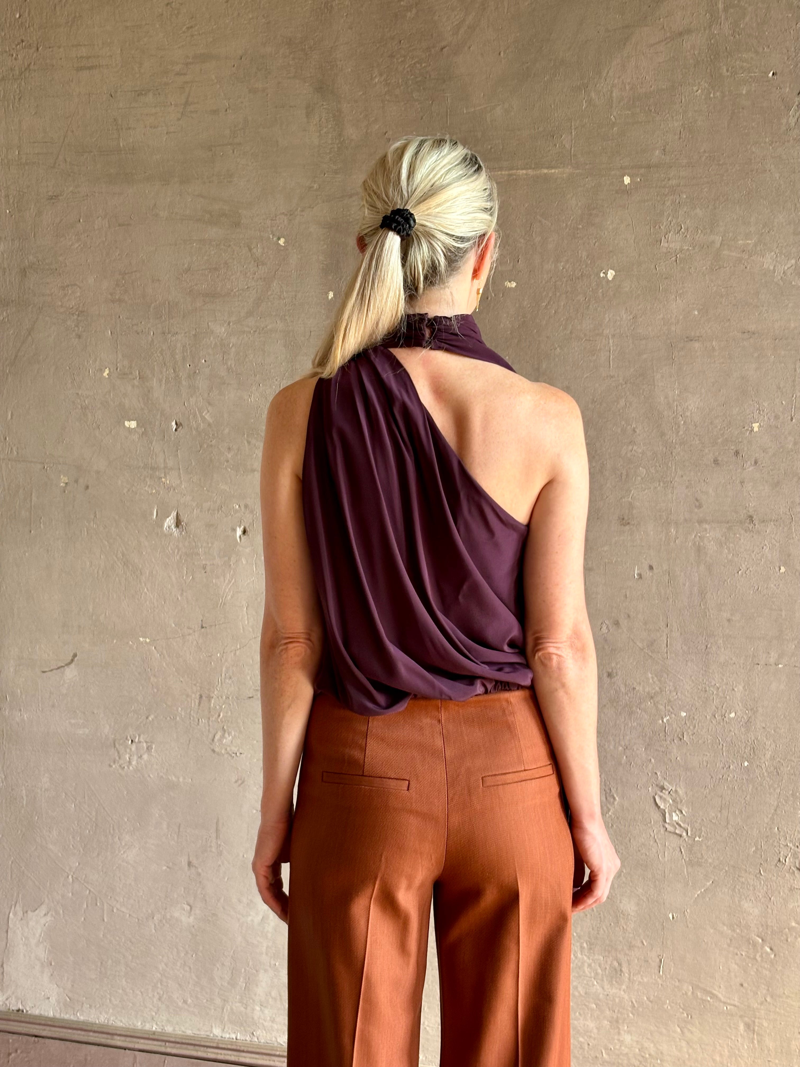 Mature model wearing ALC silk celeste top with one shoulder halter neck attached scarf sophisticated draping