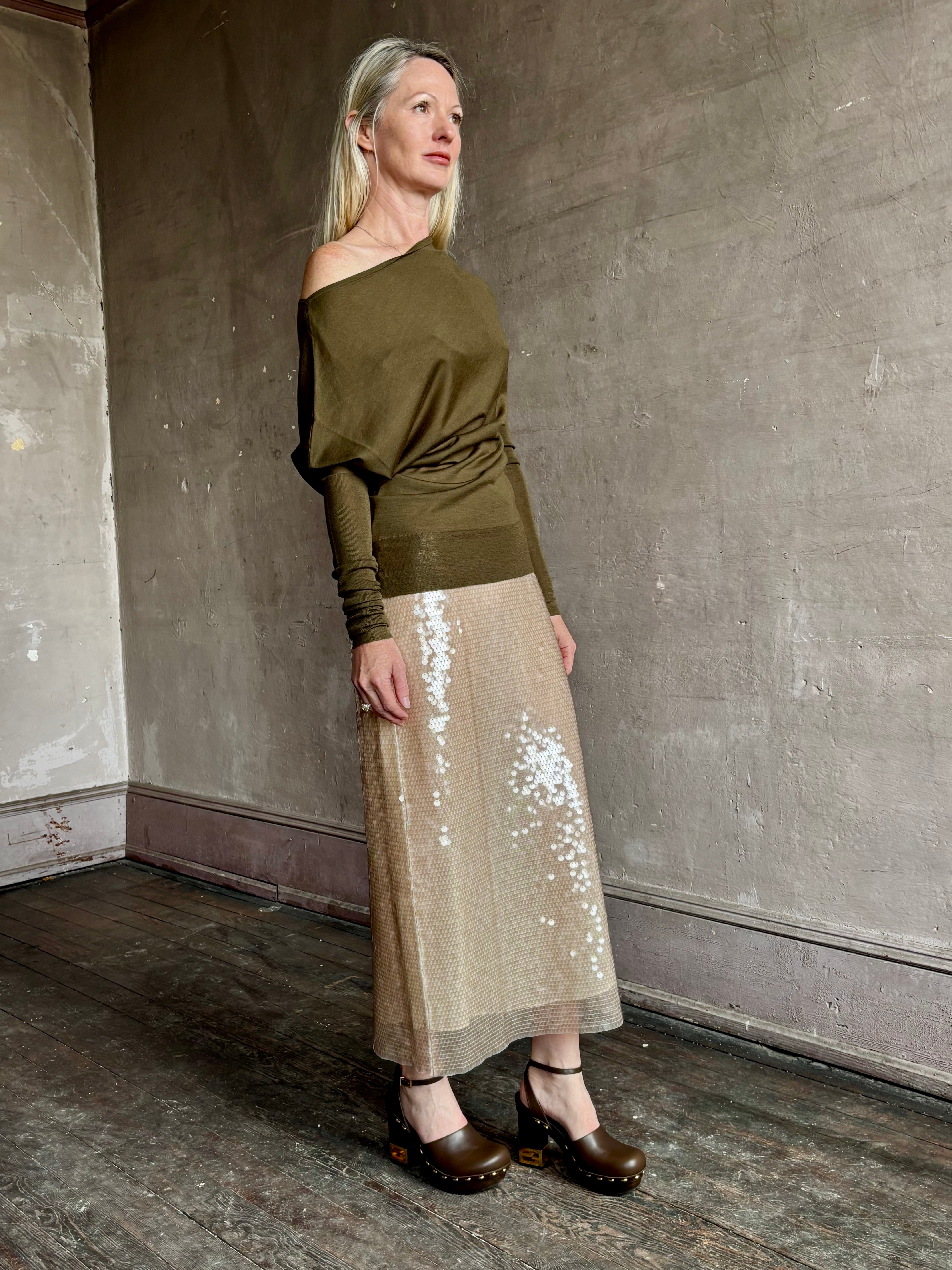 Image of a mature woman wearing contemporary fashion designer ALC Liv Top in an symmetric neckline with off-shoulder draping in army green