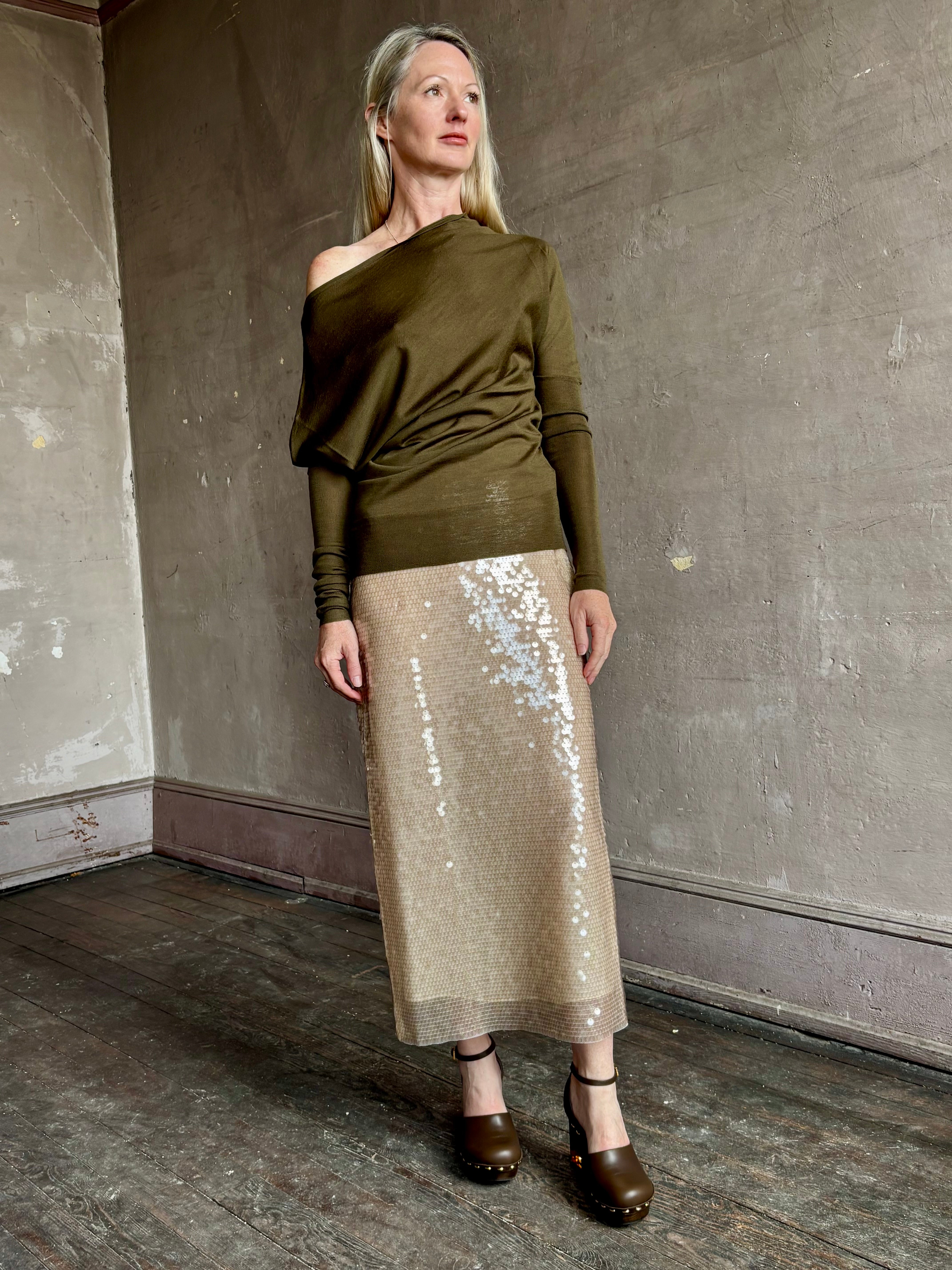 Image of a mature woman wearing contemporary fashion designer ALC Liv Top in an symmetric neckline with off-shoulder draping in army green