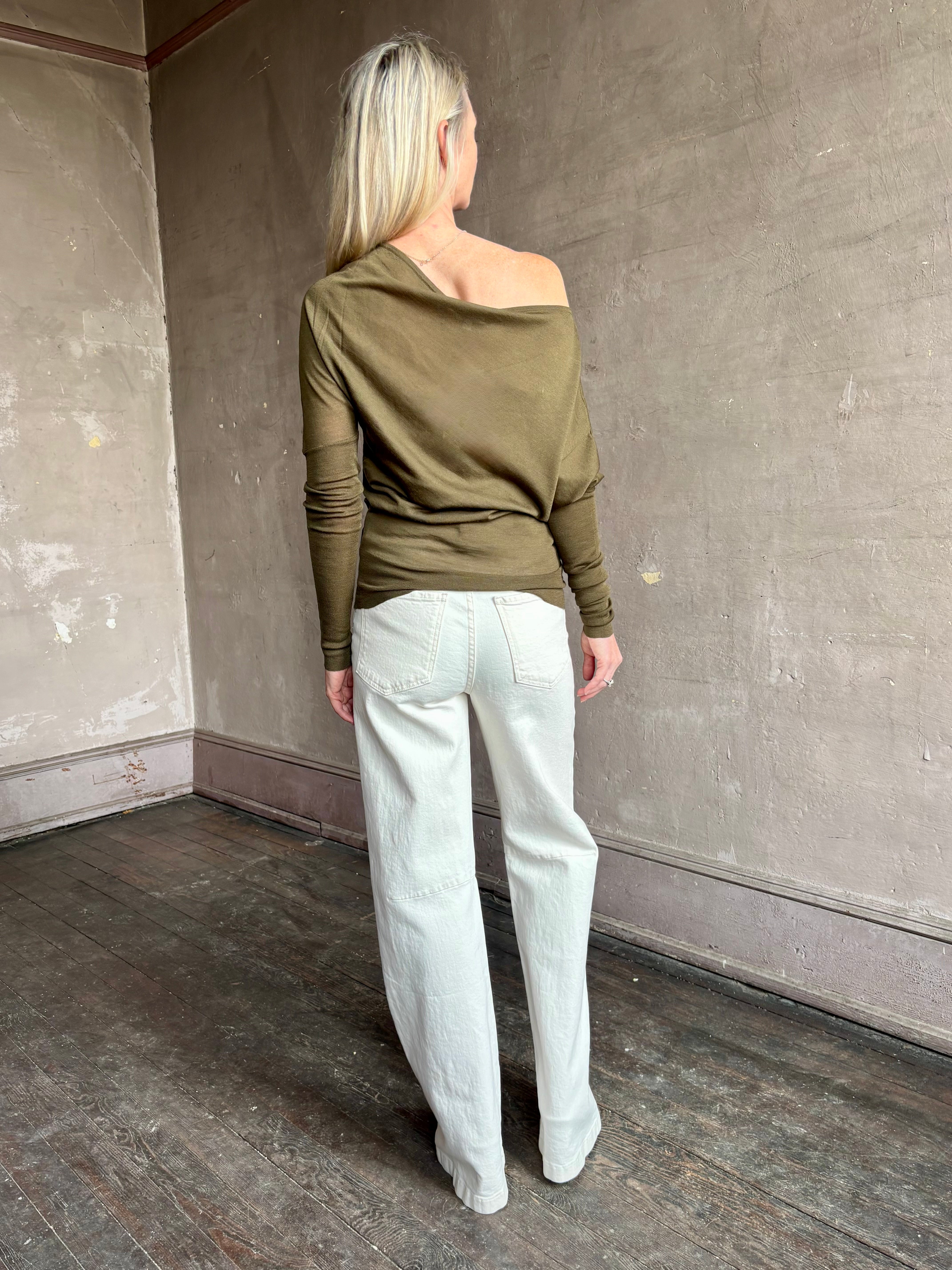 Image of a mature woman wearing contemporary fashion designer ALC Liv Top in an symmetric neckline with off-shoulder draping in army green