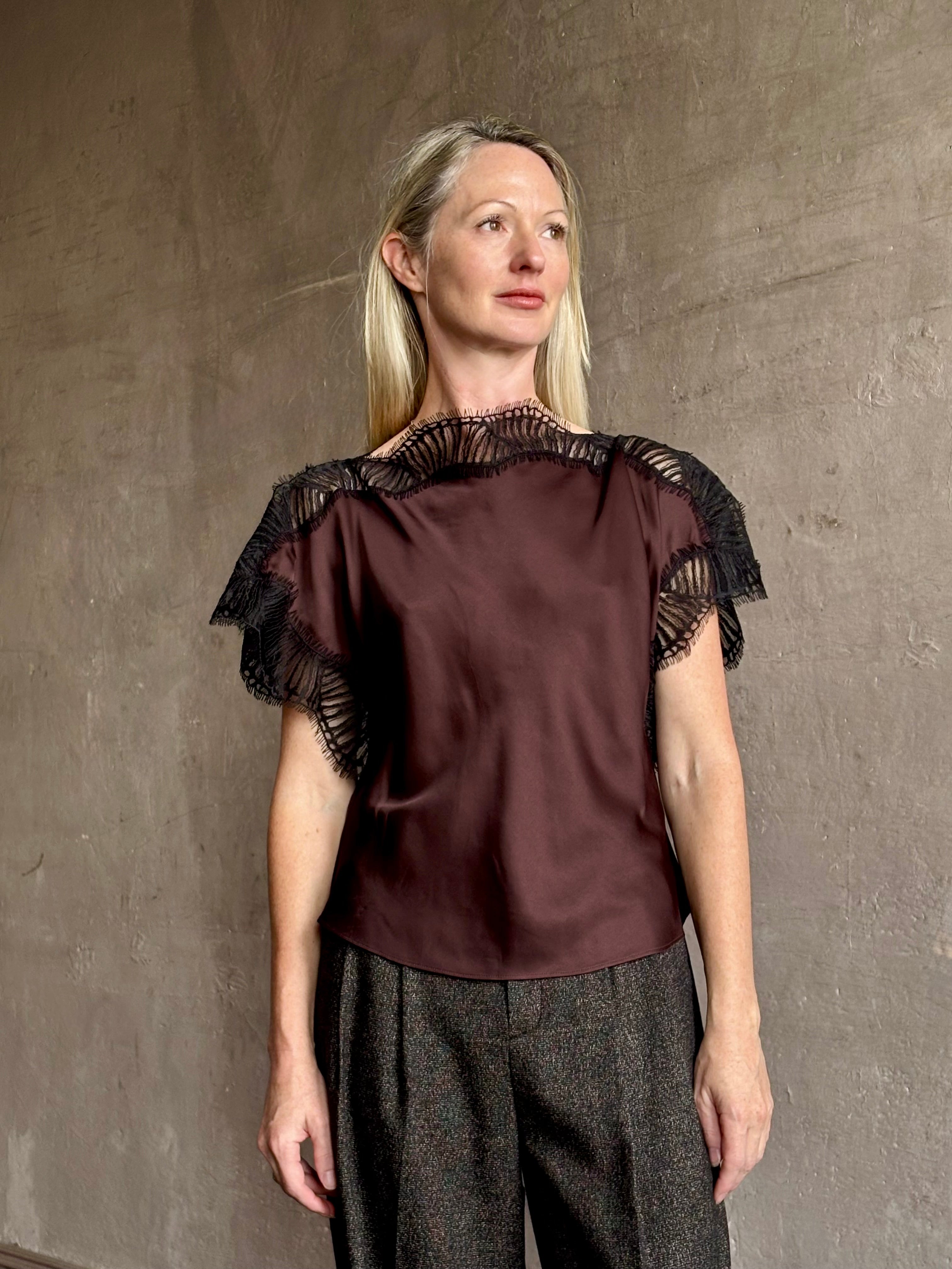 Image of mature woman wearing ALC Luna top in premium chocolate brown viscose blouse with a boat neck short sleeve and refined black lace trim