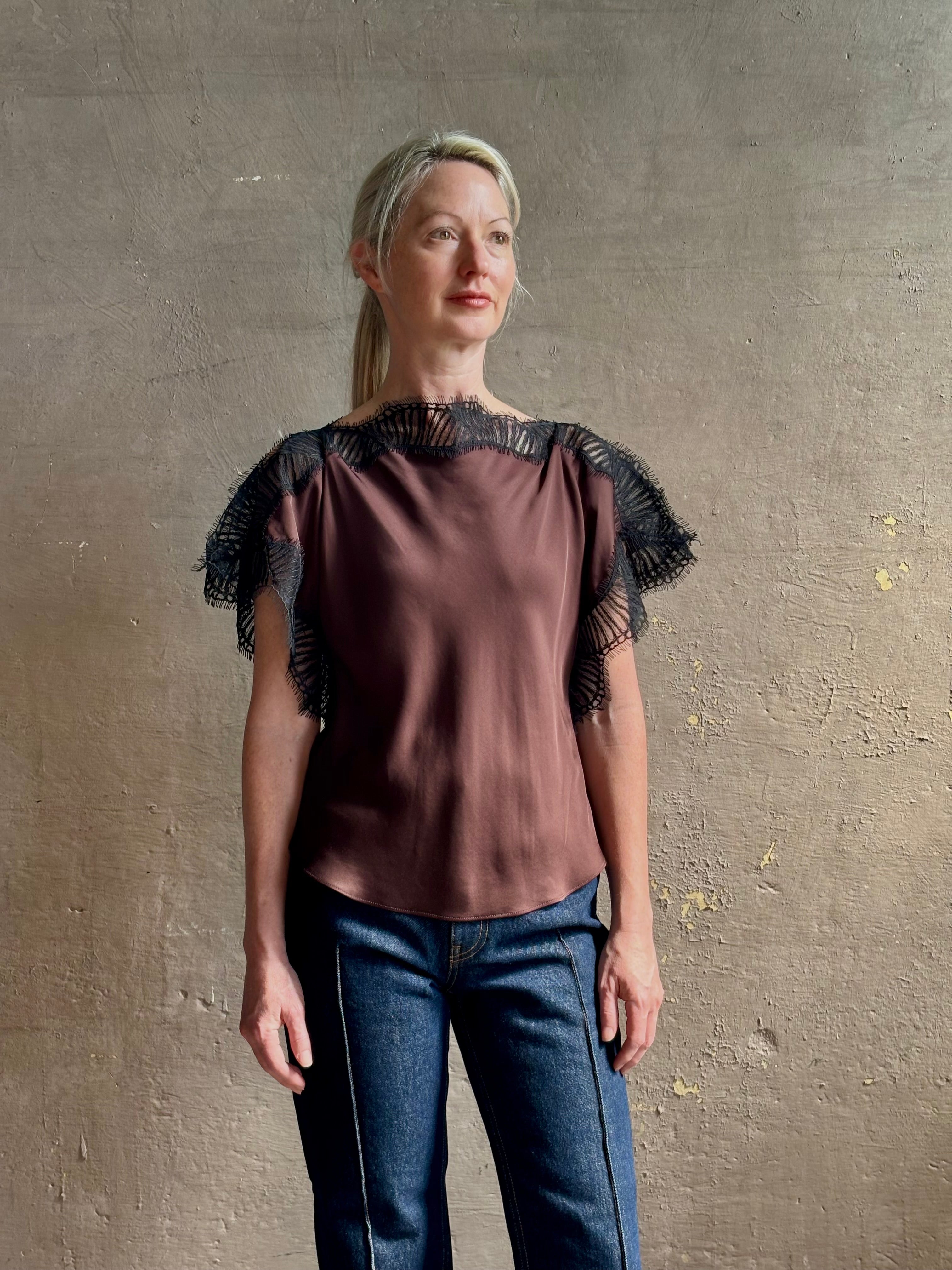 Image of mature woman wearing ALC Luna top in premium chocolate brown viscose blouse with a boat neck short sleeve and refined black lace trim