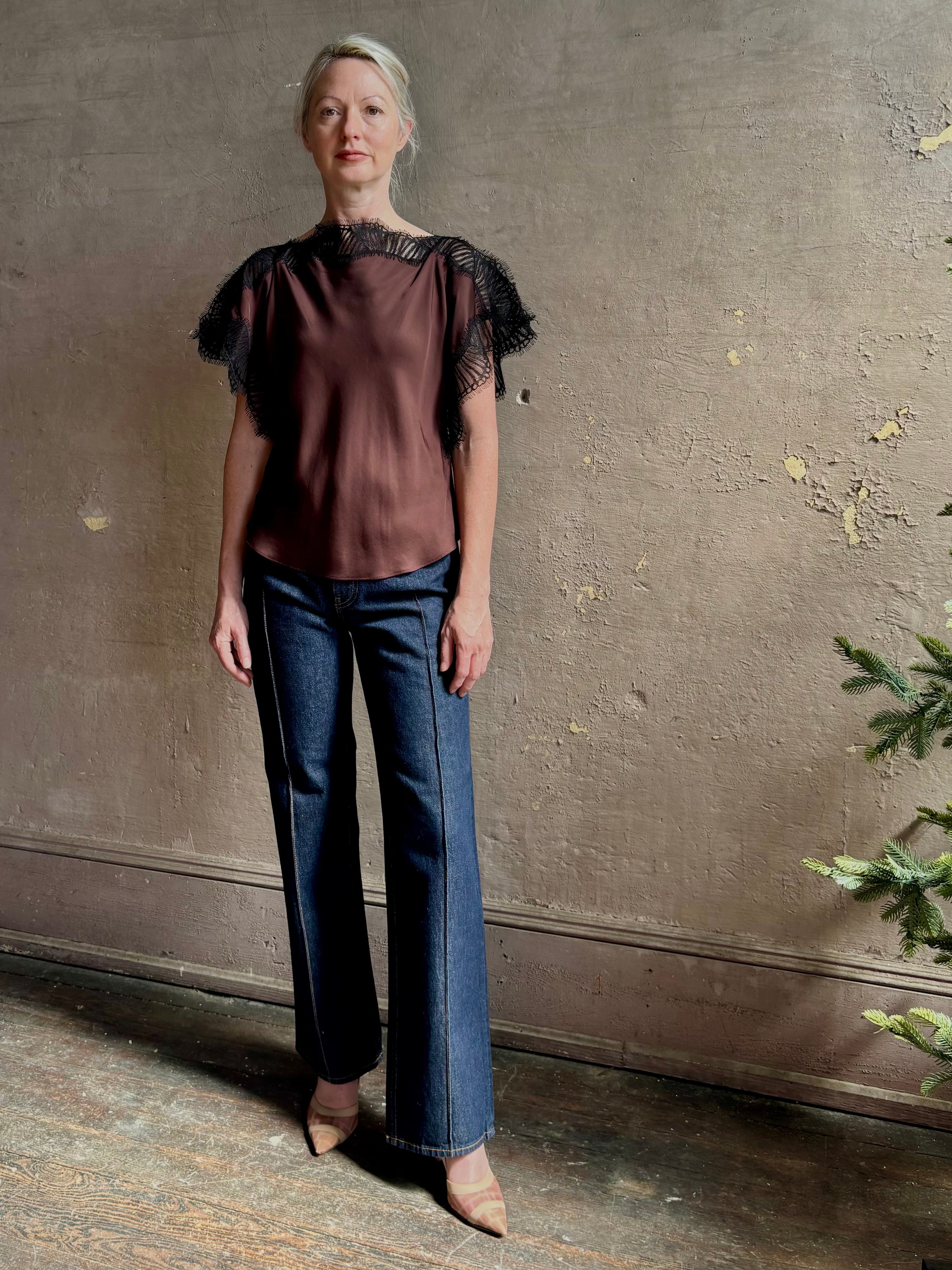 Image of mature woman wearing ALC Luna top in premium chocolate brown viscose blouse with a boat neck short sleeve and refined black lace trim