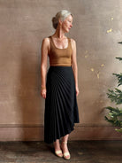 Mature woman wearing ALC Tracy skirt in black wool with asymetrical hemline and pleating