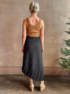 Mature woman wearing ALC Tracy skirt in black wool with asymetrical hemline and pleating