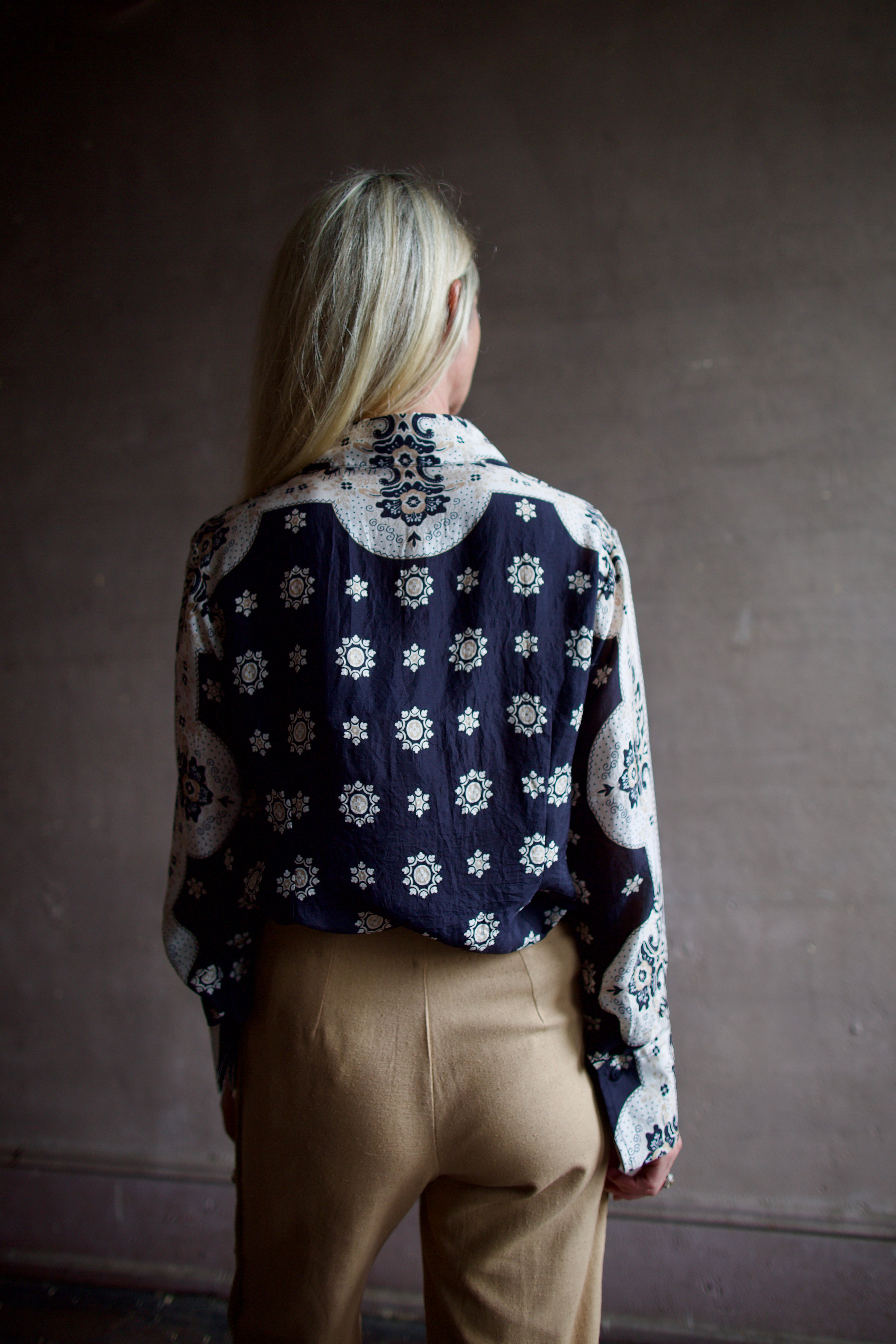 Model wearing an Alix of Bohemia bandana blouse and silk beige Alix trousers