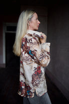 Model wearing a hand woven western Alix of Bohemia blouse with Veronica Beard grey barrel jeans 