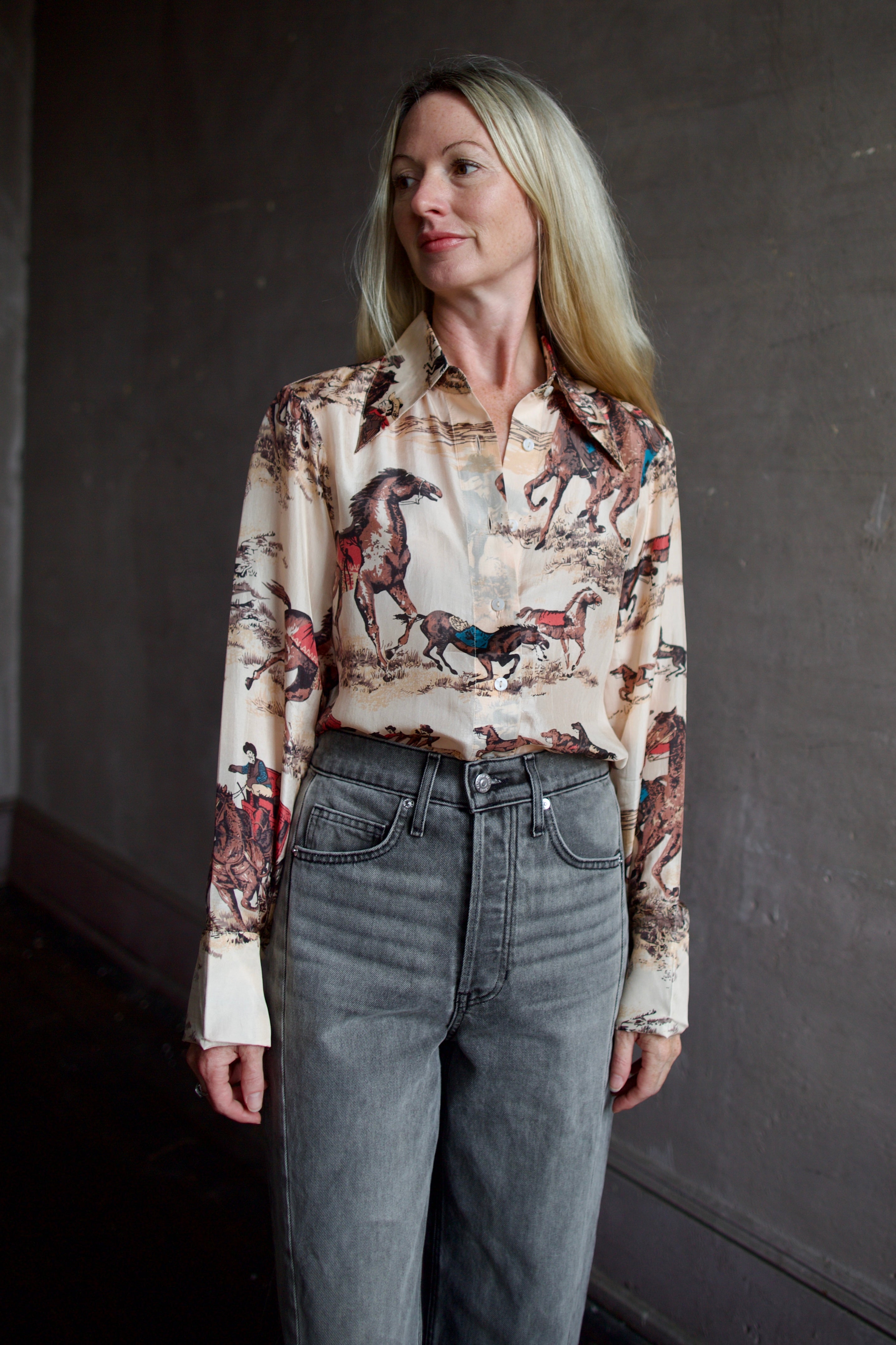 Model wearing a hand woven western Alix of Bohemia blouse with Veronica Beard grey barrel jeans 