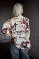 Back of a hand woven western Alix of Bohemia blouse with Veronica Beard grey barrel jeans 