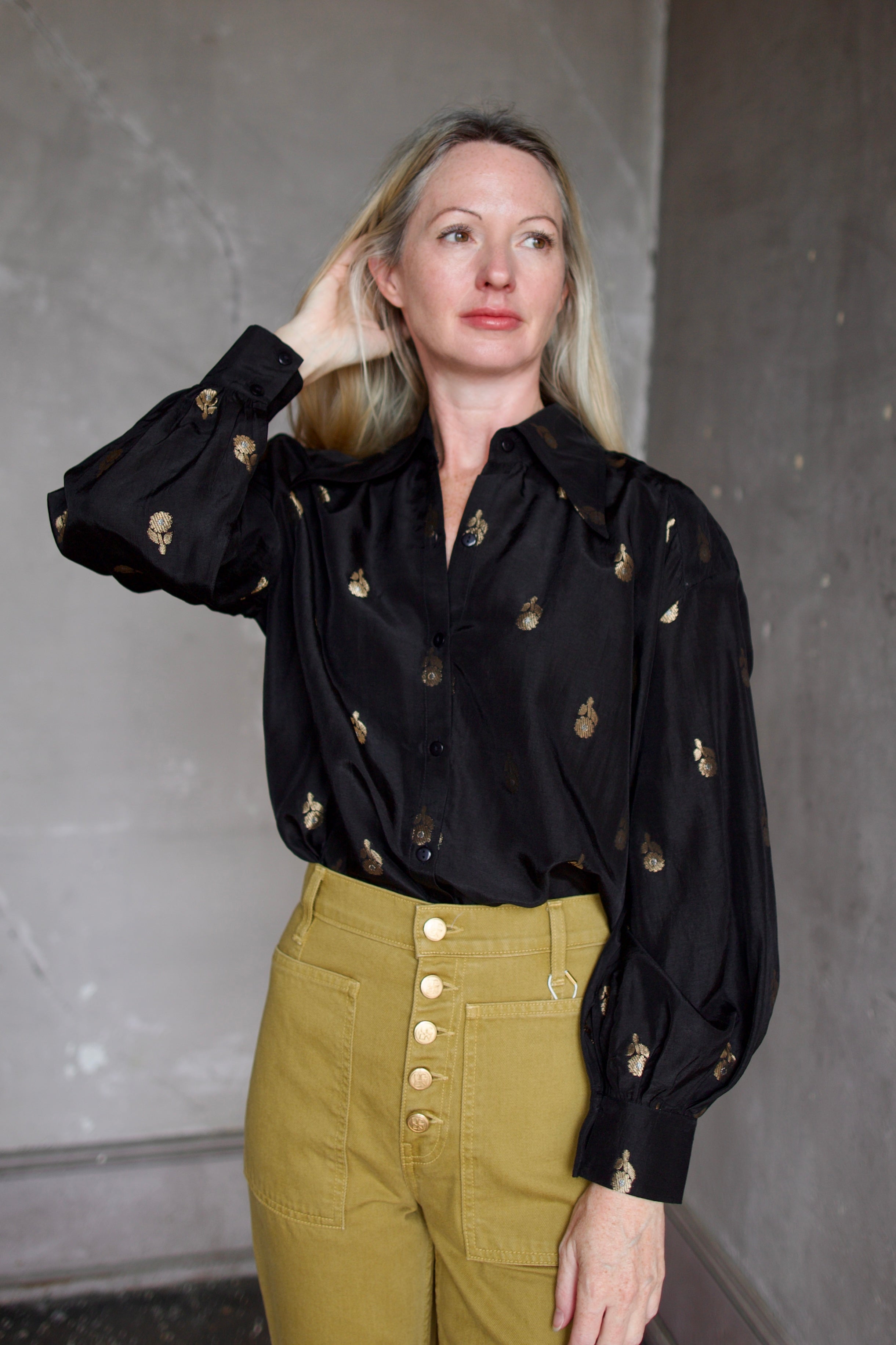 Model wearing Alix of Bohemia Emery Shadow Shirt. Black shirt has bamboo construction and subtle gold metallic accents.