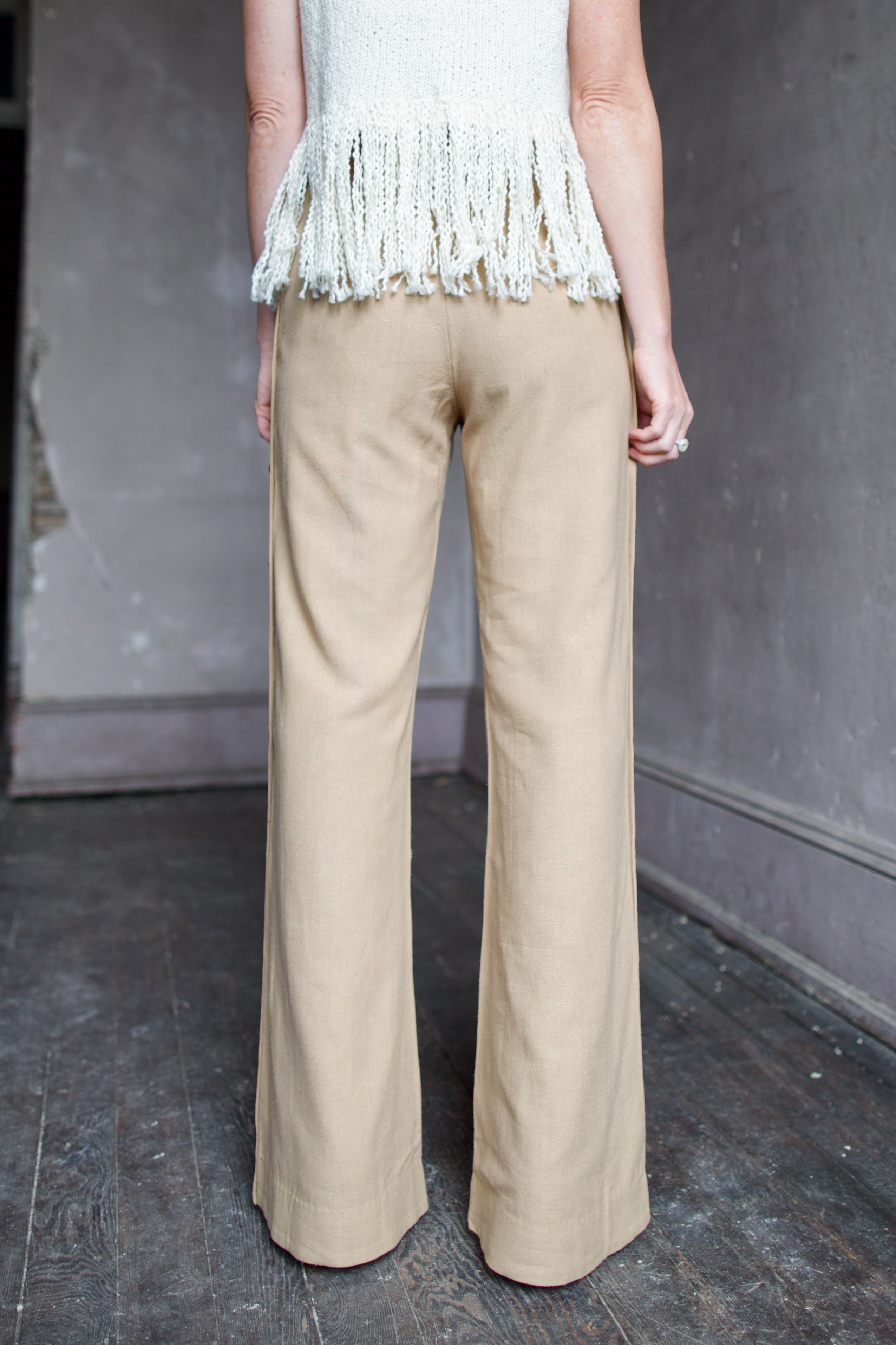 Back of neutral silk Alix of Bohemia trousers with operable silver button details