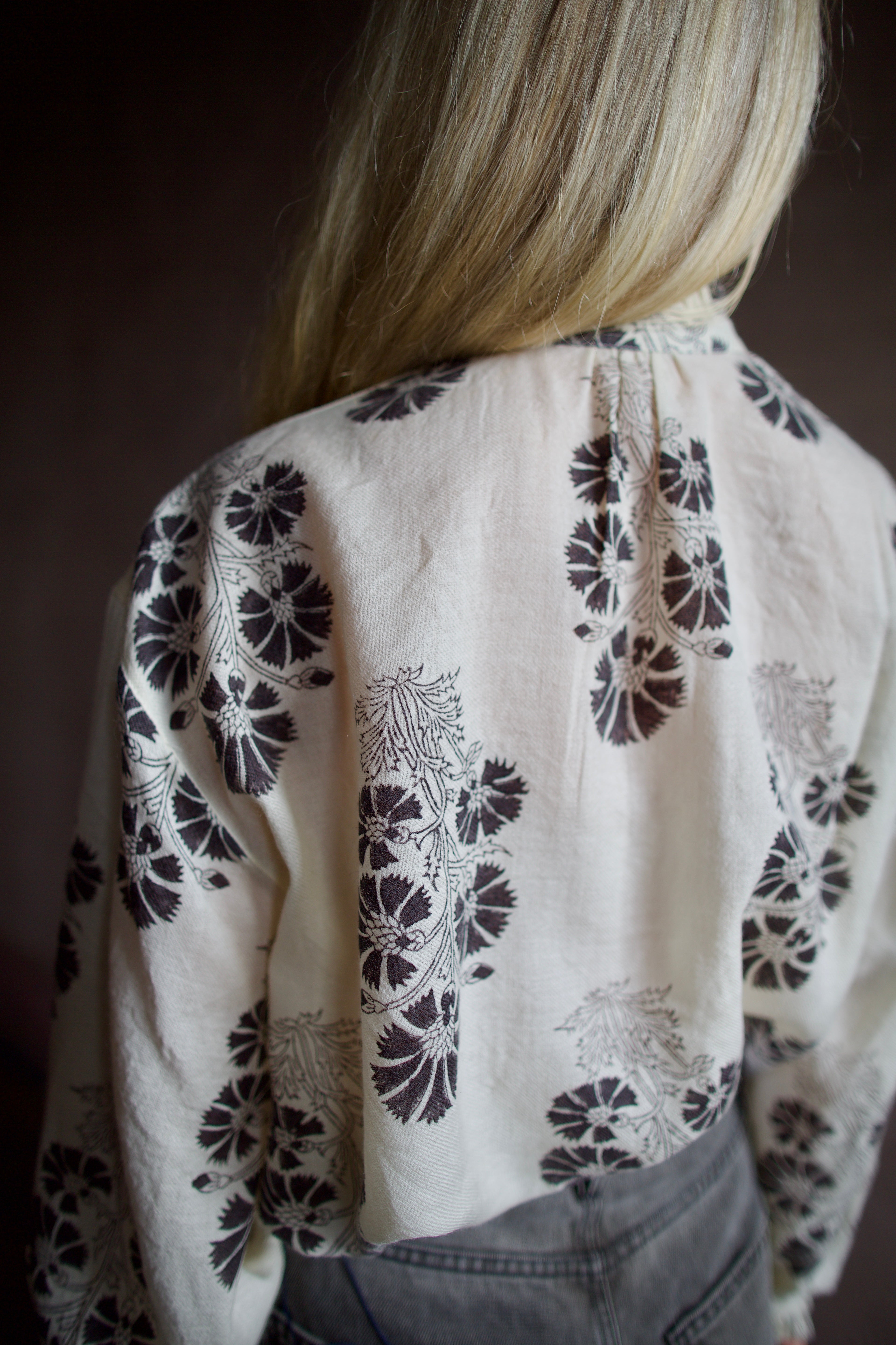 Barck of Poet Alix of Bohemia wool floral blouse and Veronica Beard high-waisted grey barrel jeans.