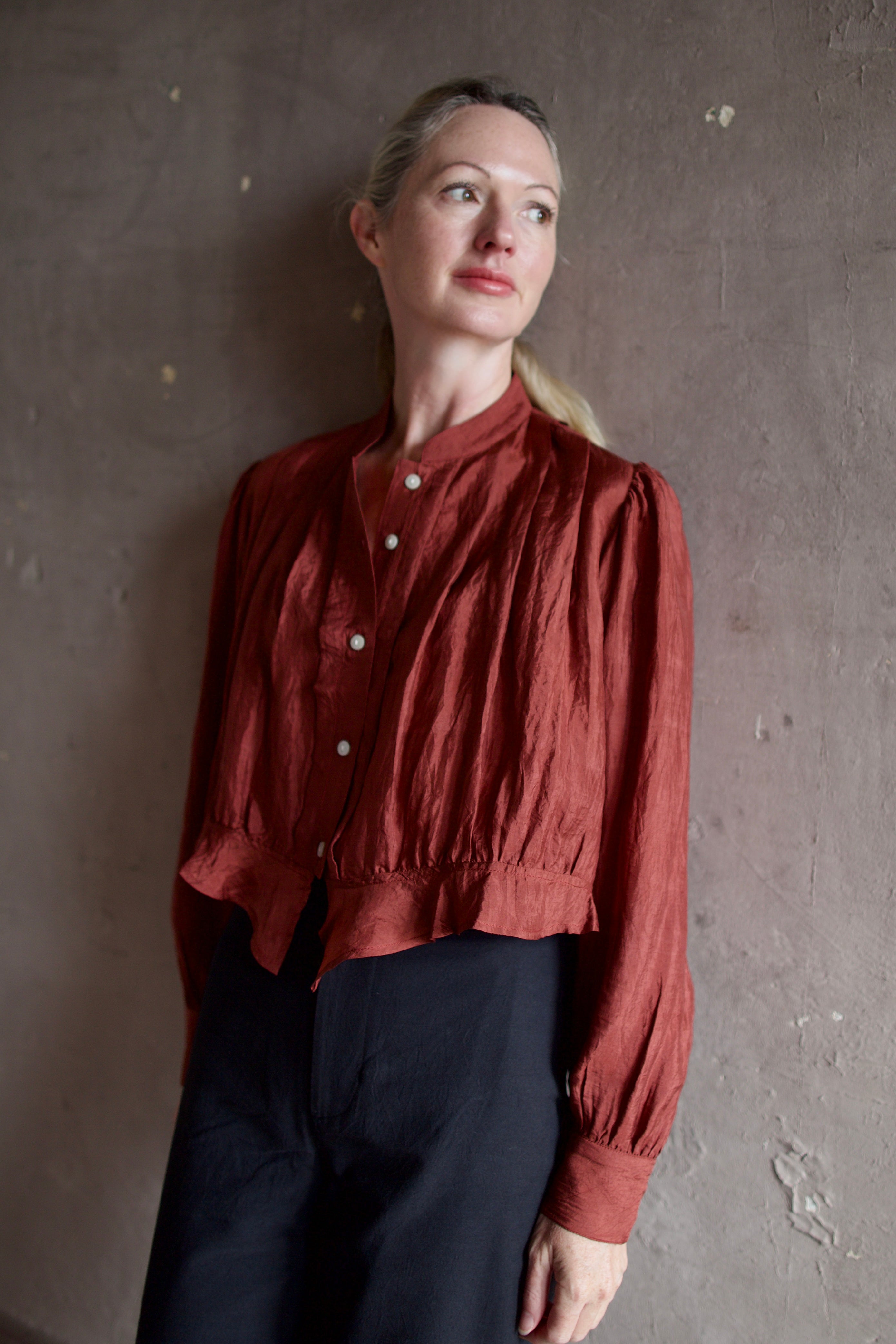 Model wearing Alix of Bohemia Ryland Saddle Shirt. Blouse has classic Edwardian design with premium silk construction and expert pleating techniques.