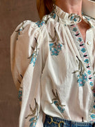 Image of woman wearing ALIX OF BOHEMIA Artemis Sky Mist Flower Shirt with Off-White background and aqua and pink floral print