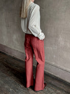 Woman wearing designer ALIX OF BOHEMIA Charlie Red Ochre Silk Pant with belt loops and back pockets