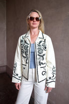Mature woman wearing the Alix of Bohemia Francis Bone Snake Jacket in black and white colorway with luxury 100% silk fabric and Bohemian refinement