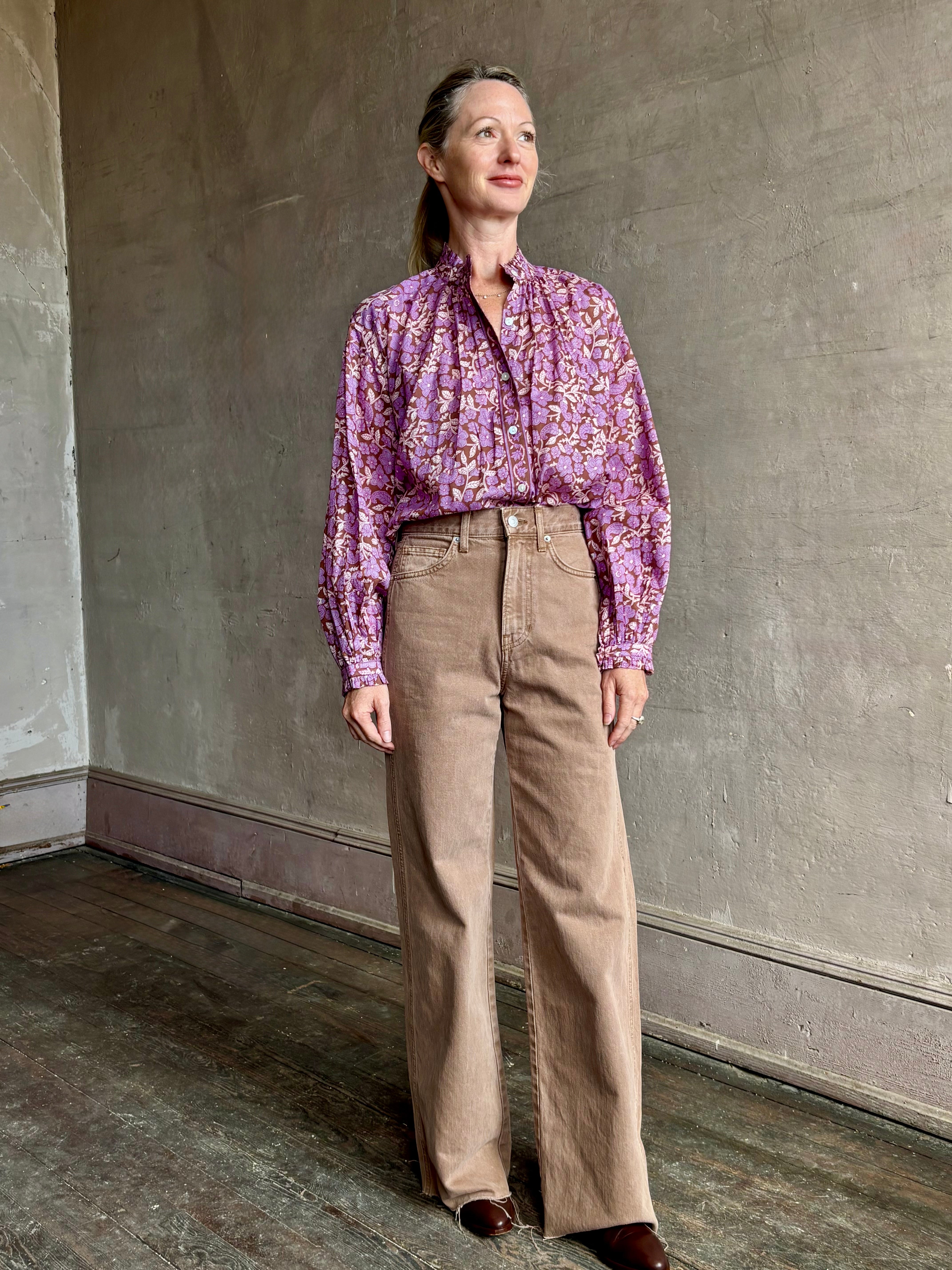 Image of woman wearing Alix of Bohemia feminine purple blouse with mandarin collar styling and delicate ruffle accents in a small floral print