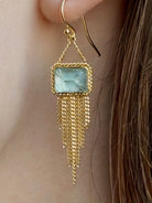 Woman wearing handmade New York designer Amali rectangular aquamarine and 18k yellow gold drop earrings with elegant  gold fringe dangle embellishments