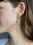 Woman wearing handmade New York designer Amali rectangular aquamarine and 18k yellow gold drop earrings with elegant  gold fringe dangle embellishments