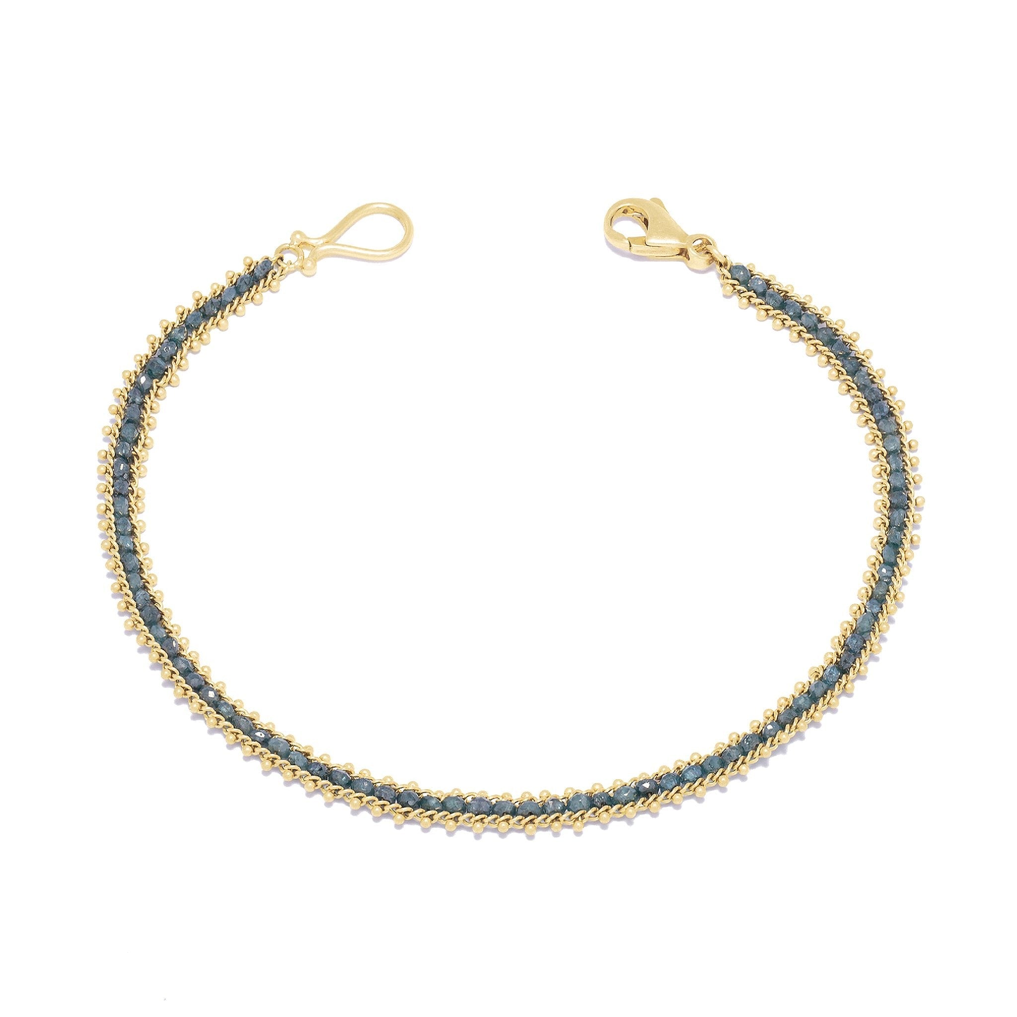 Image of the vivid natural blue diamond row bracelet designed by NC fine jeweler Amali in warm 18K yellow gold
