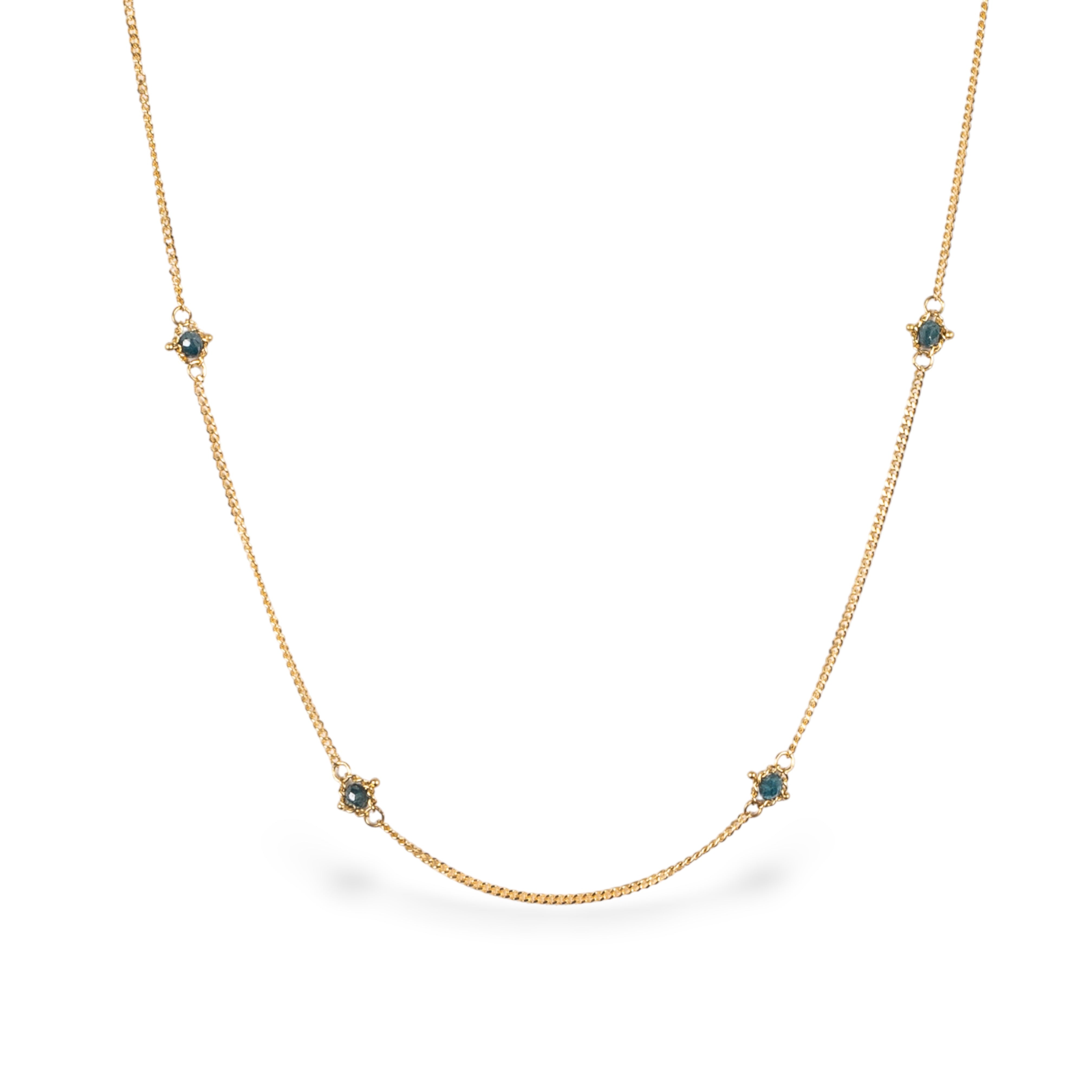 Close up image of a natural blue diamond chain necklace handcrafted by  North Carolina fine jewelry designer Amali in warm 18K yellow gold with a refreshing contemporary design