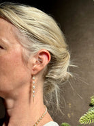 Image of graduated Akoya Pearl Drop Earrings from North Carolina fine jewelry artist Amali with each lustrous white Akoya pearl individually suspended in hand-woven lengths of delicate 18K yellow gold chain and french wire hooks