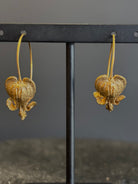 Image of Bleeding Heart Hoop Earrings from North Carolina fine Jewelry artist Amber Mahler handcrafted 18K yellow gold vermeil botanical casting. 