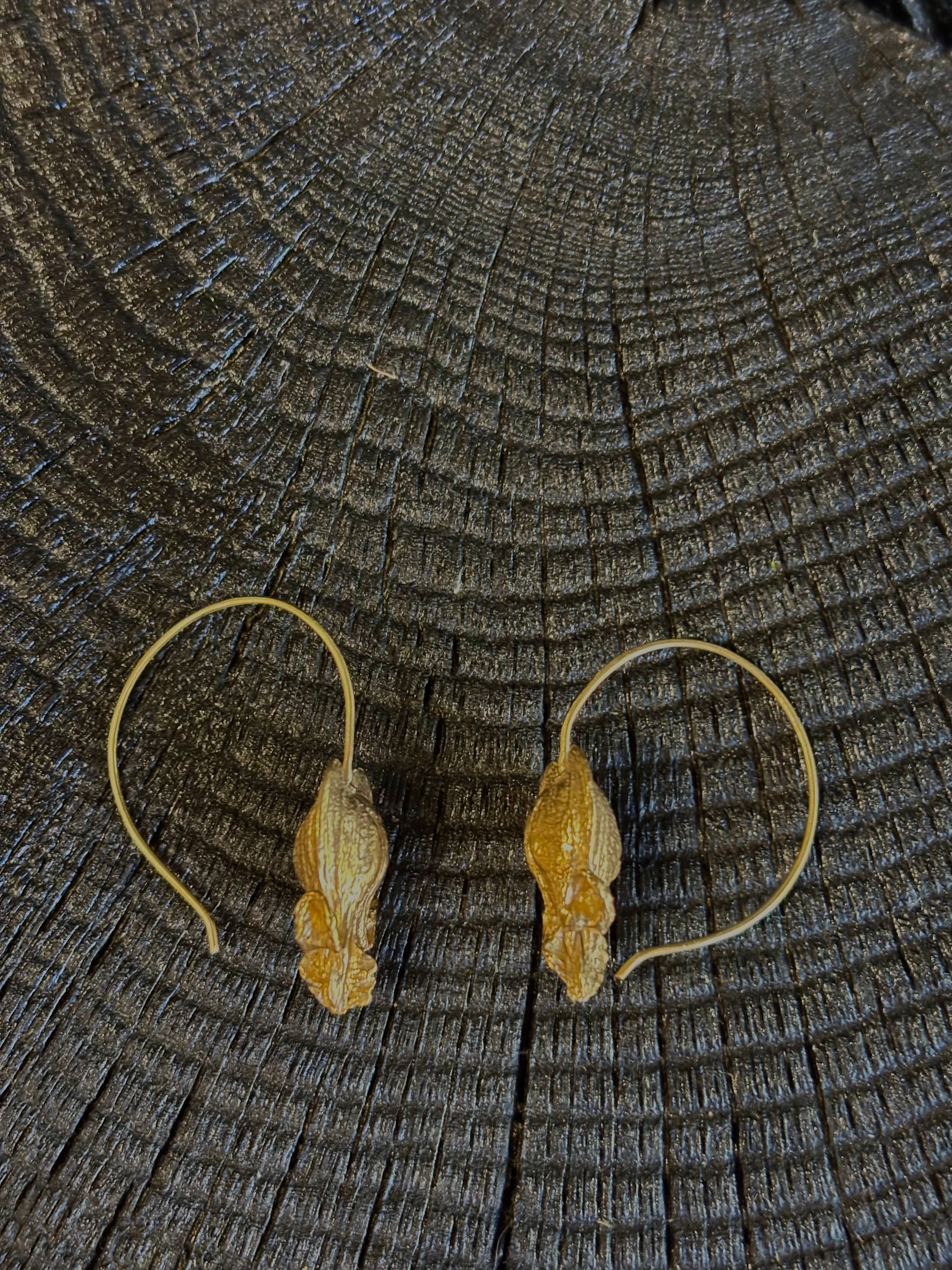 Image of Bleeding Heart Hoop Earrings from North Carolina fine Jewelry artist Amber Mahler handcrafted 18K yellow gold vermeil botanical casting. 