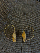 Image of Bleeding Heart Hoop Earrings from North Carolina fine Jewelry artist Amber Mahler handcrafted 18K yellow gold vermeil botanical casting. 