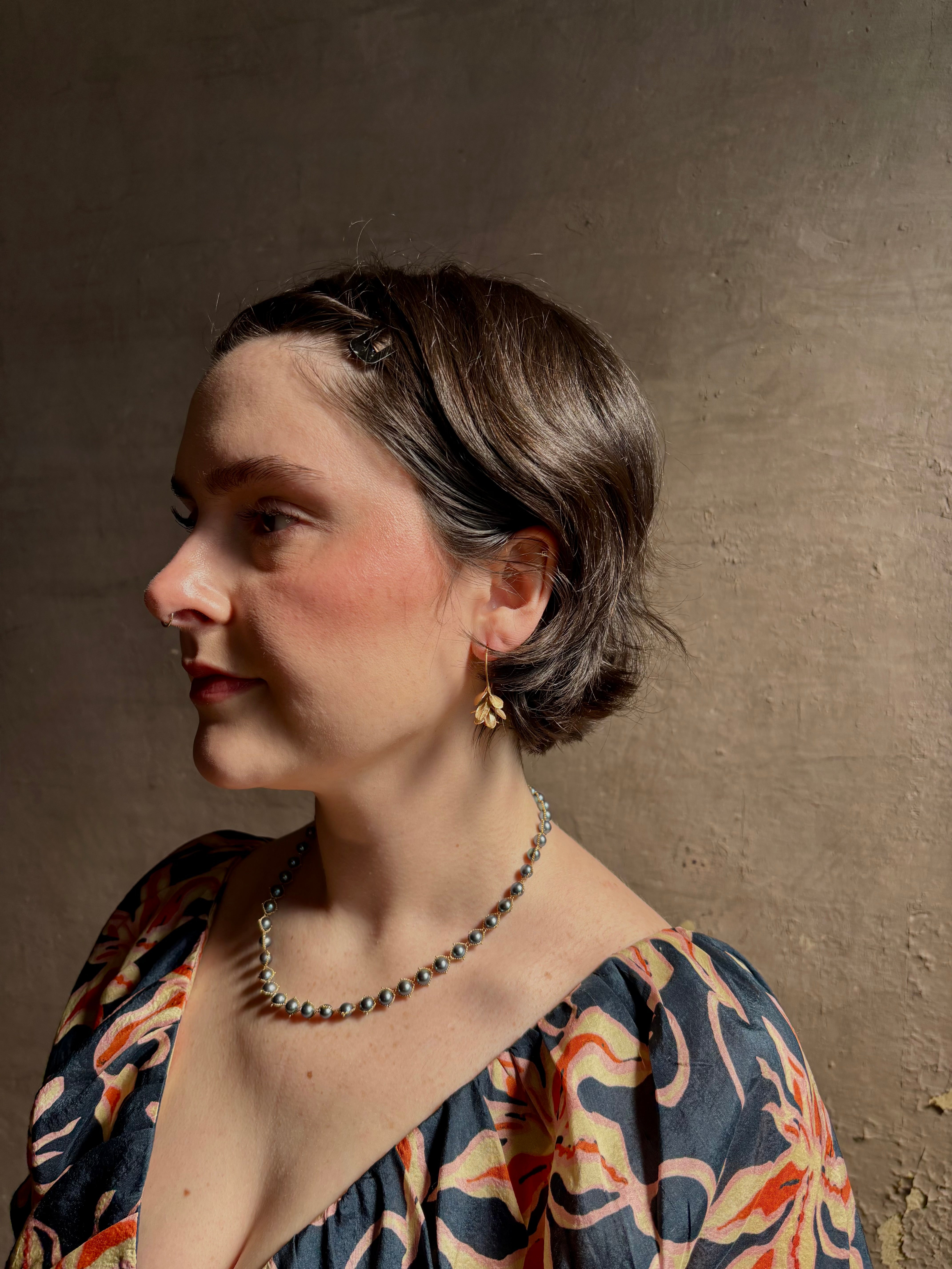 Woman wearing Four Petal Succulent Hoop Earrings from North Carolina fine jewelry artist Amber Mahler handcrafted 18K yellow gold vermeil botanical casting